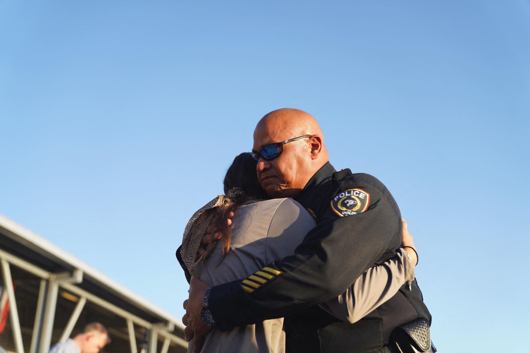 Un oficial de policía consuela a una mujer durante una vigilia por las víctimas del tiroteo masivo en la Escuela Primaria Robb en Uvalde, Texas. Foto: AFP