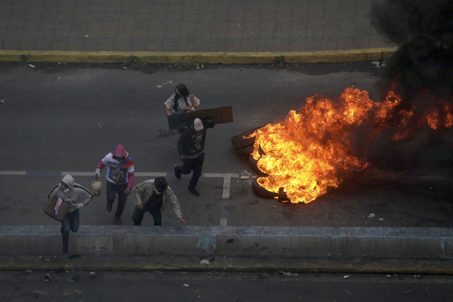 Manifestantes queman neumáticos durante enfrentamientos con antidisturbios en el parque El Ejido, en Quito. AFP