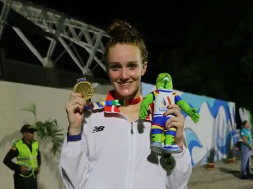 La nadadora peruana Mckenna De Bever muestra su medalla ganada en los 100m. espalda femenino.