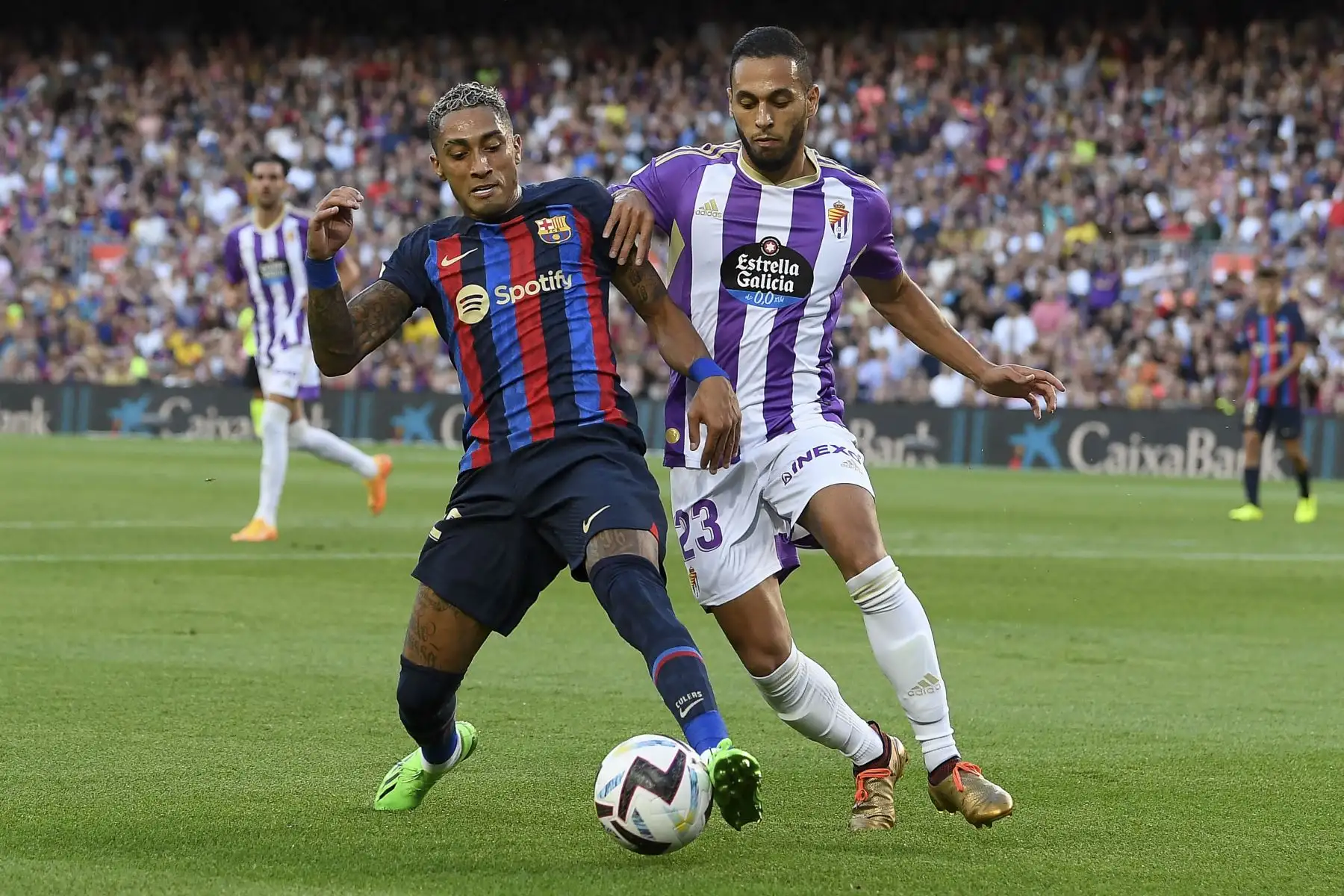 El delantero brasileño de Barcelona Raphinha (L) lucha por el balón con el centrocampista marroquí del Real Valladolid Anuar Mohamed durante el partido de fútbol de la Liga española entre el FC Barcelona y el Real Valladolid FC en el estadio Camp Nou de Barcelona. Foto: AFP