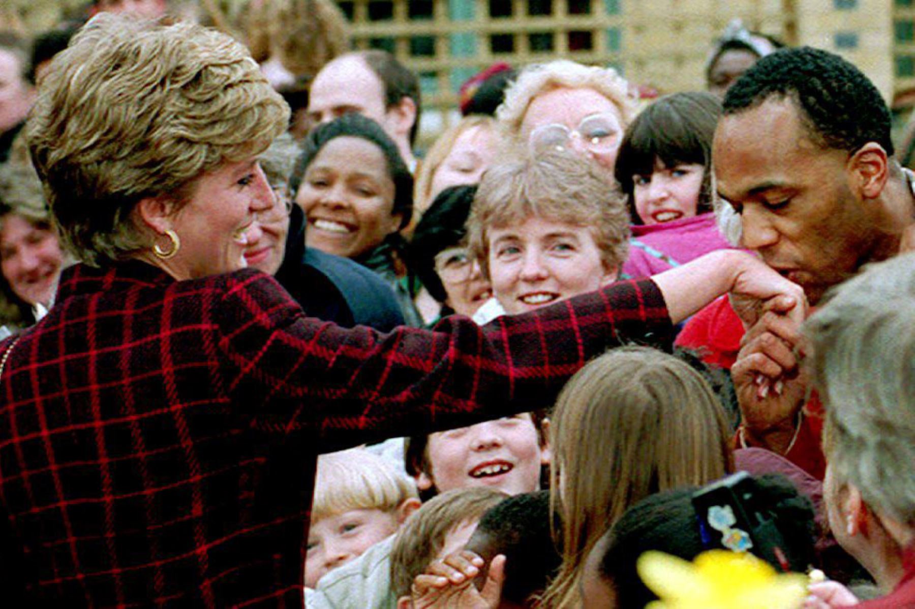 En esta foto de archivo tomada el 10 de marzo de 1993, la princesa Diana recibe un beso en la mano del aprendiz de electricista Danny Walters, de 29 años, durante una caminata en Southwark, al sur de Londres. Foto: AFP
