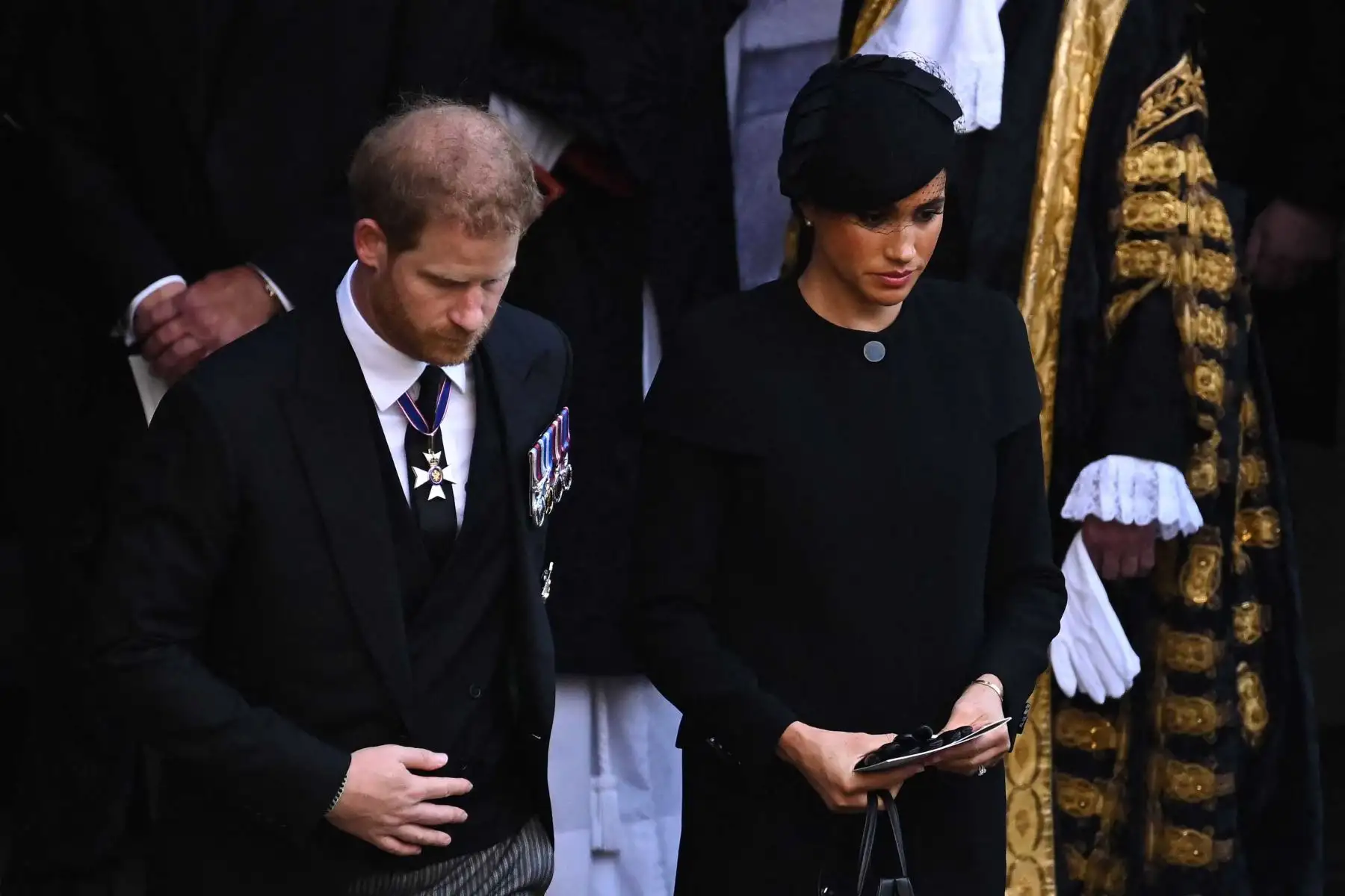 El príncipe Harry, el duque de Sussex y Meghan, duquesa de Sussex de Gran Bretaña se van después de un servicio para la recepción del ataúd de la reina Isabel II en Westminster Hall, en el Palacio de Westminster en Londres. Foto: AFP