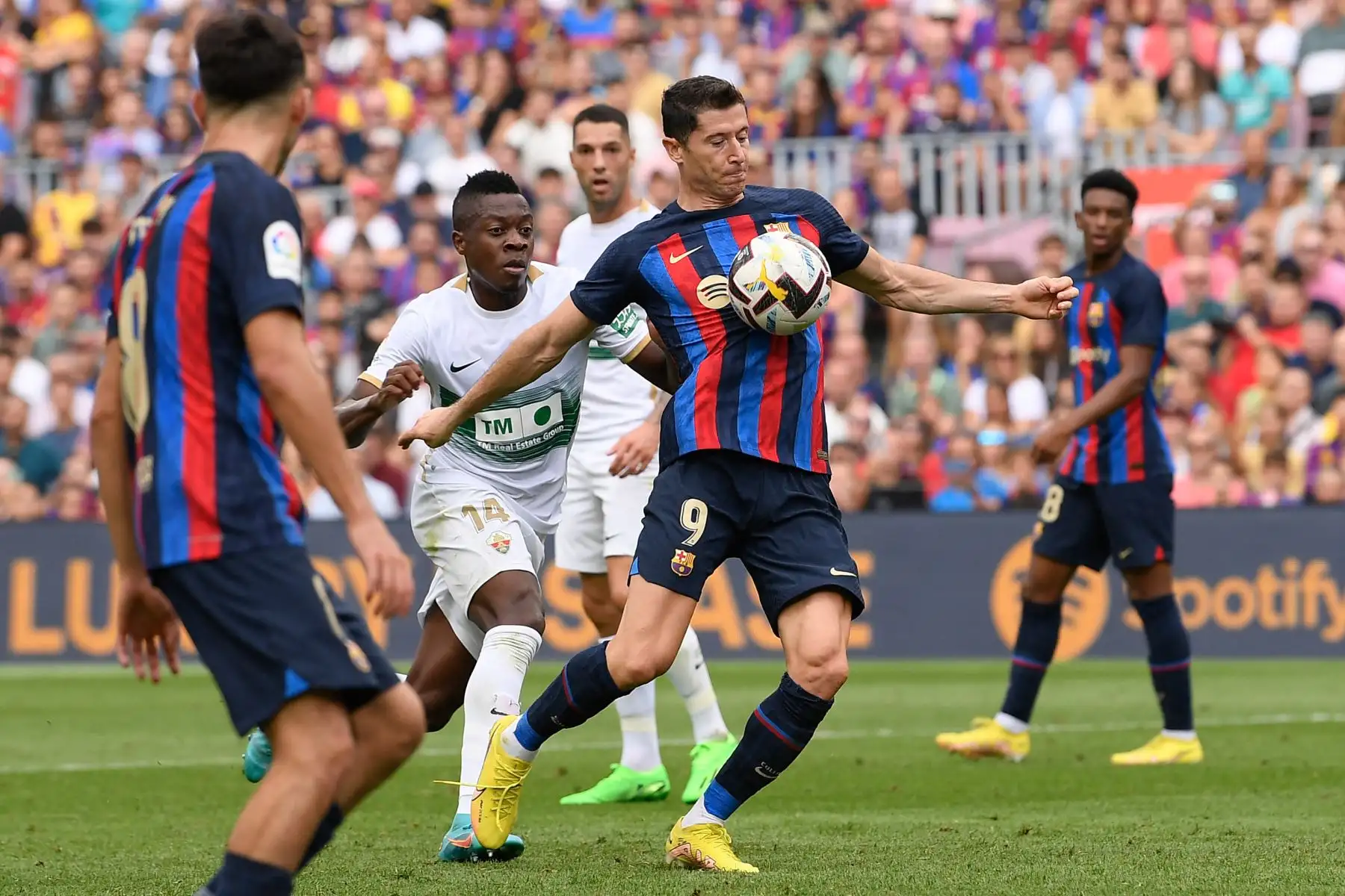El delantero polaco de Barcelona, Robert Lewandowski (R), es desafiado por el defensor colombiano de Elche, Helibelton Palacios, durante el partido de fútbol de la Liga española entre el FC Barcelona y el Elche CF en el estadio Camp Nou de Barcelona. Foto: AFP