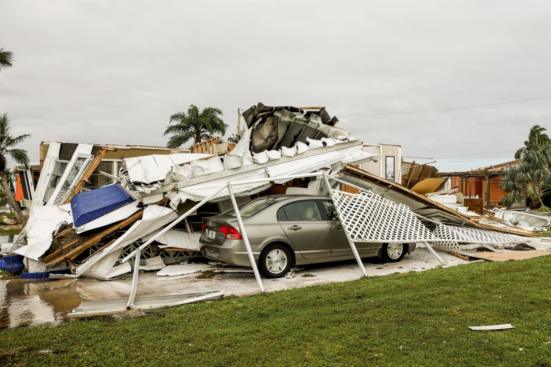 Un vehículo se encuentra debajo de un edificio derrumbado tras el paso del huracán Ian en Fort Myers, Florida, EE. la costa este de Florida. 
Foto: ANDINA/EFE