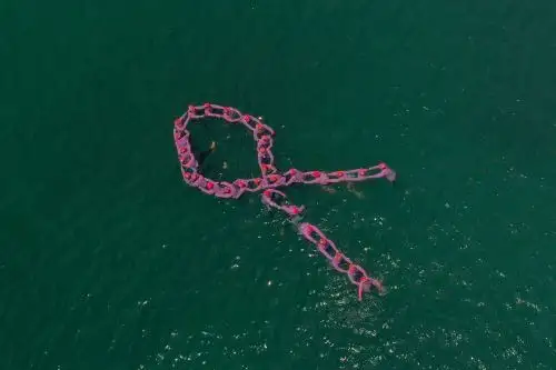 Colectivo de mujeres "Las truchas" formaron lazo rosado en el mar de la playa Agua Dulce. ANDINA/ EsSalud
