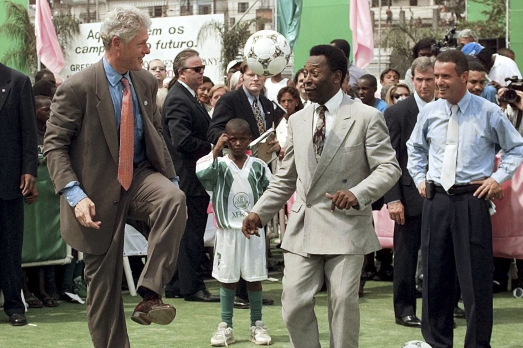 El presidente de los Estados Unidos, Bill Clinton (izquierda), hace rebotar un balón de fútbol en su rodilla ante la leyenda del fútbol brasileño, Pelé (derecha), el 15 de octubre durante una visita a la Escuela Mangueira en la favela del mismo nombre en Río de Janeiro.

Foto:AFP