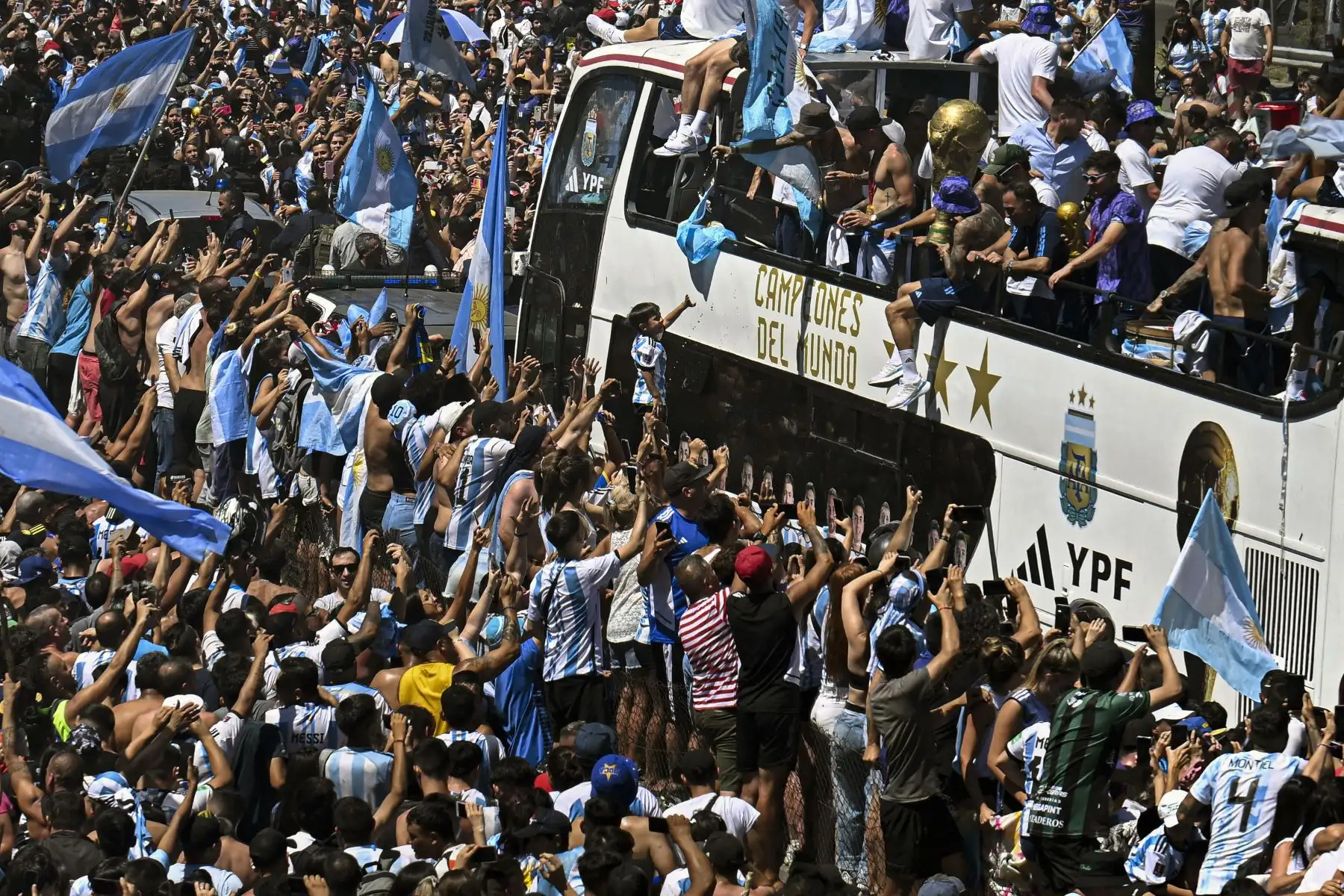 Los fanáticos de Argentina animan mientras el equipo desfila a bordo de un autobús después de ganar el torneo de la Copa Mundial de Qatar 2022 en Buenos Aires, Argentina, el 20 de diciembre de 2022.  Foto: AFP