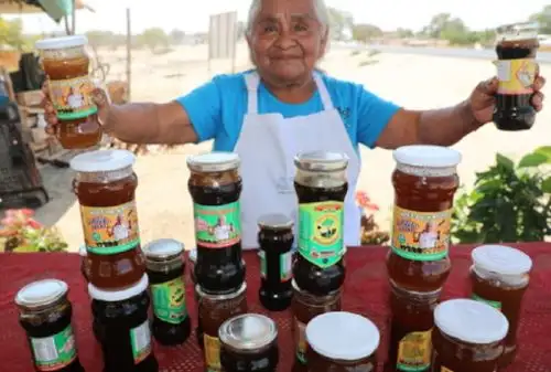 María Juana Rosa Rivas de Pacherres, usuaria de Pensión 65 y guardiana del bosque seco en Piura, prepara algarrobina y miel de algarroba.