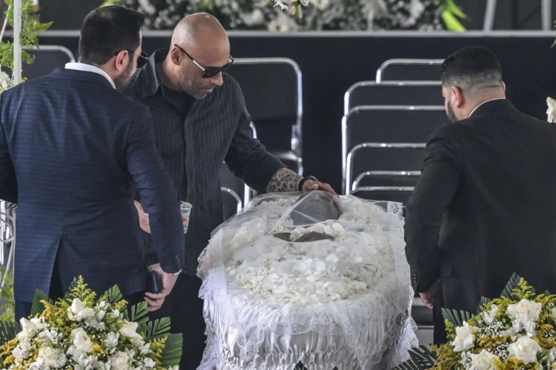 Edinho, hijo de la difunta leyenda del fútbol brasileño Pelé, reza junto a su ataúd durante su velorio en el estadio Urbano Caldeira en Santos, Sao Paulo, Brasil. Foto: AFP