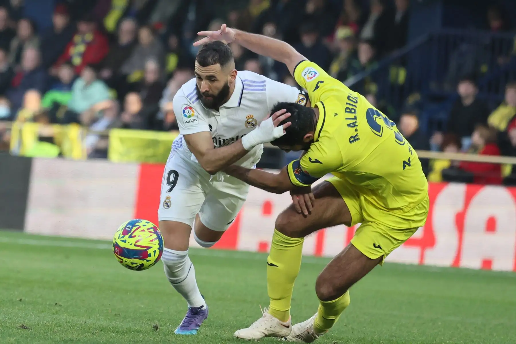 El delantero francés del Real Madrid, Karim Benzema, compite con el defensor español del Villarreal, Raúl Albiol, durante el partido de fútbol de la Liga española entre el Villarreal CF y el Real Madrid. Foto: AFP