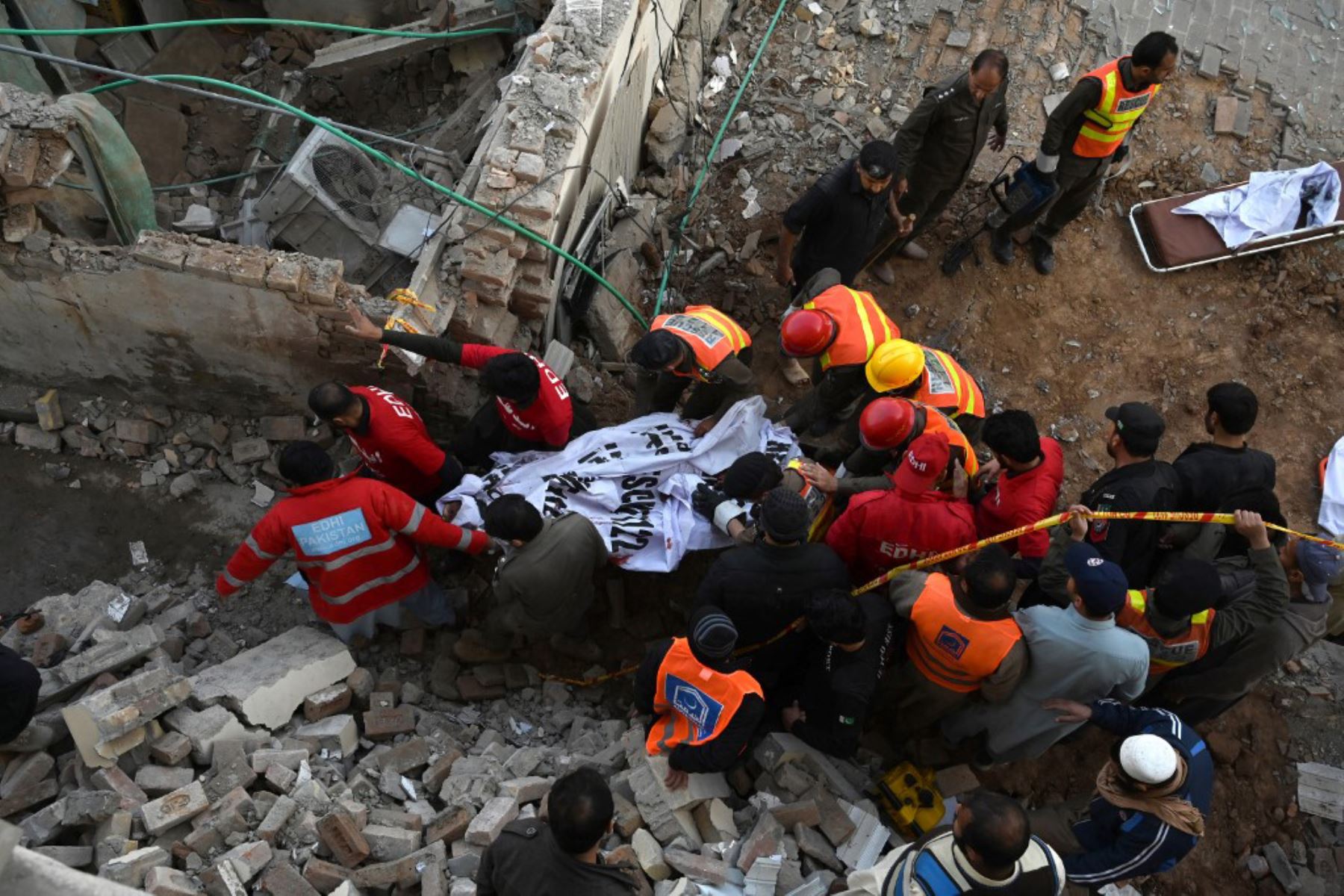 Personal de seguridad y rescatistas buscan víctimas de la explosión entre los escombros de una mezquita en Peshawar. Foto: AFP