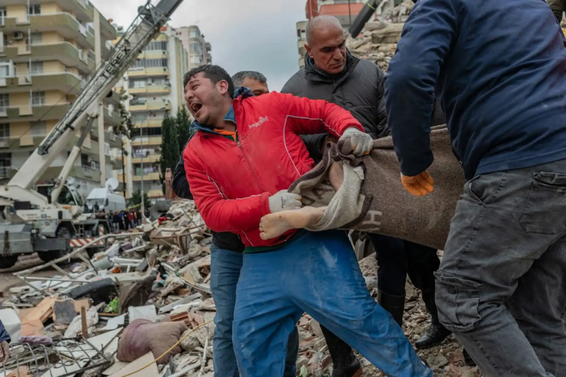 Un rescatista reacciona mientras lleva un cuerpo encontrado entre los escombros en Adana, después de que un terremoto de magnitud 7,8 azotara el sureste del país. Foto: AFP