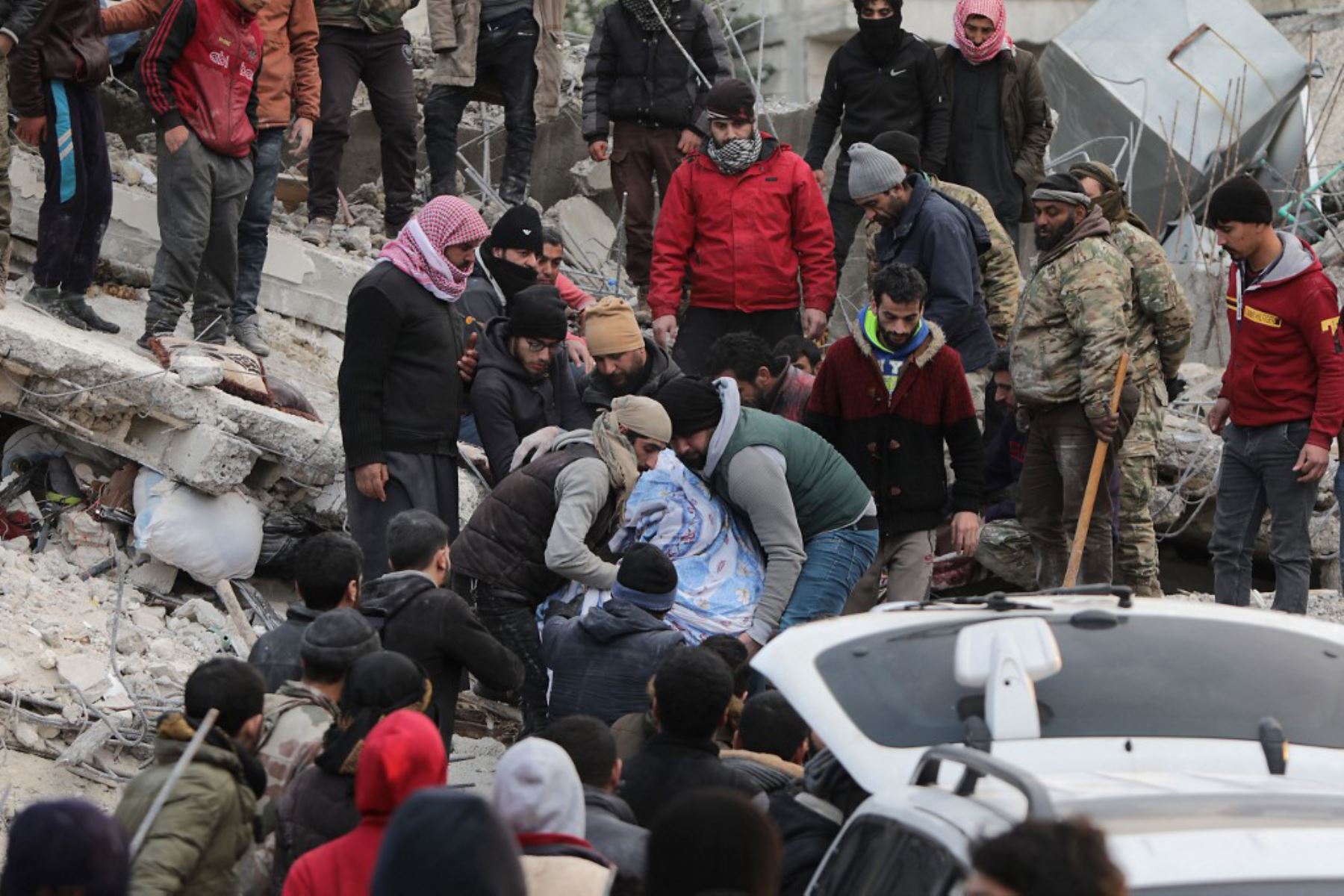Los sirios recuperan un cuerpo de los escombros de un edificio derrumbado, en la ciudad de Jandairis. Foto: AFP