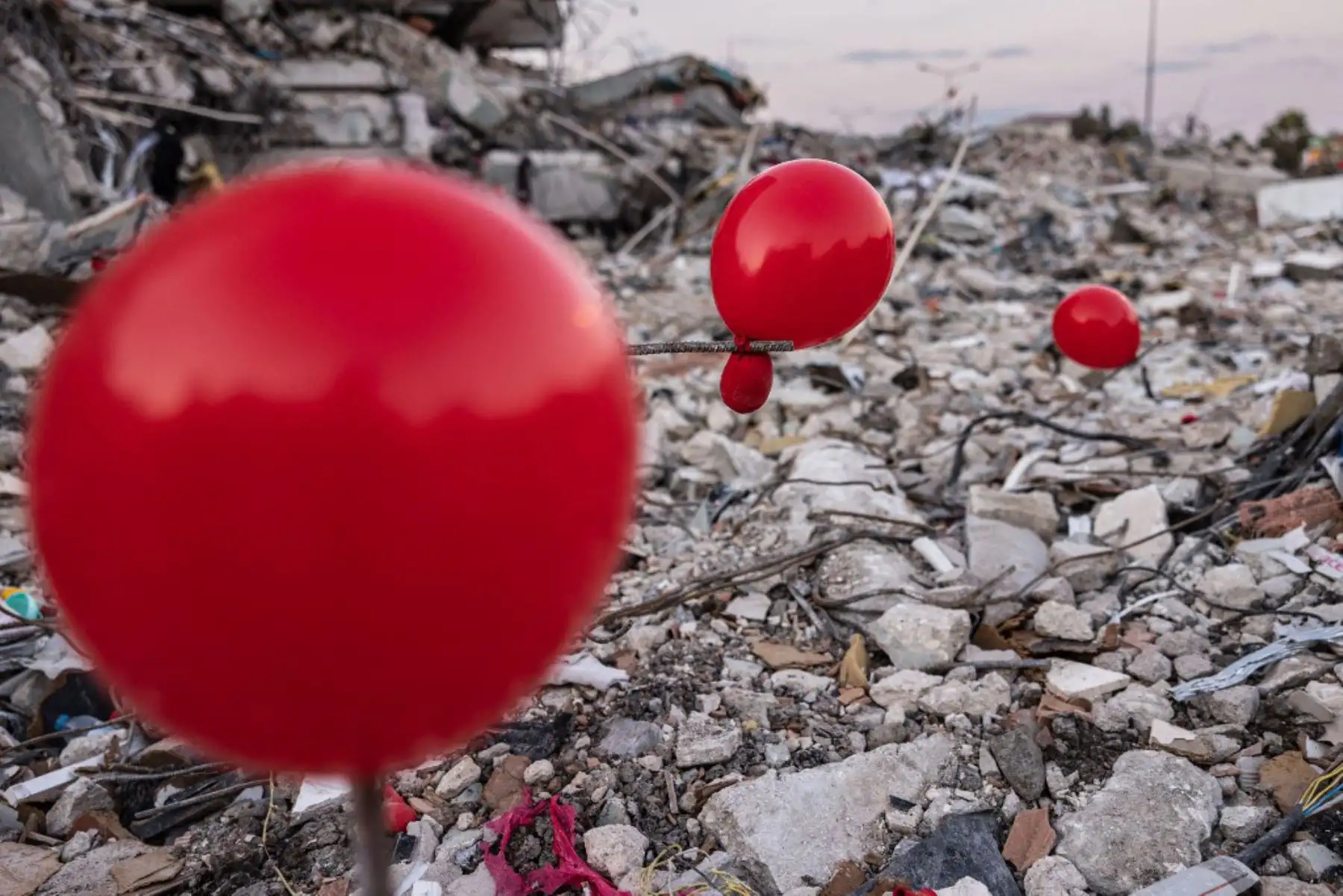 Globos colgando de los escombros de un edificio derrumbado en Antakya, al sur de Turquía, dos semanas después de que un terremoto de magnitud 7,8 azotara cerca de Gaziantep y causara la muerte de más de 44.000 personas. Foto: AFP