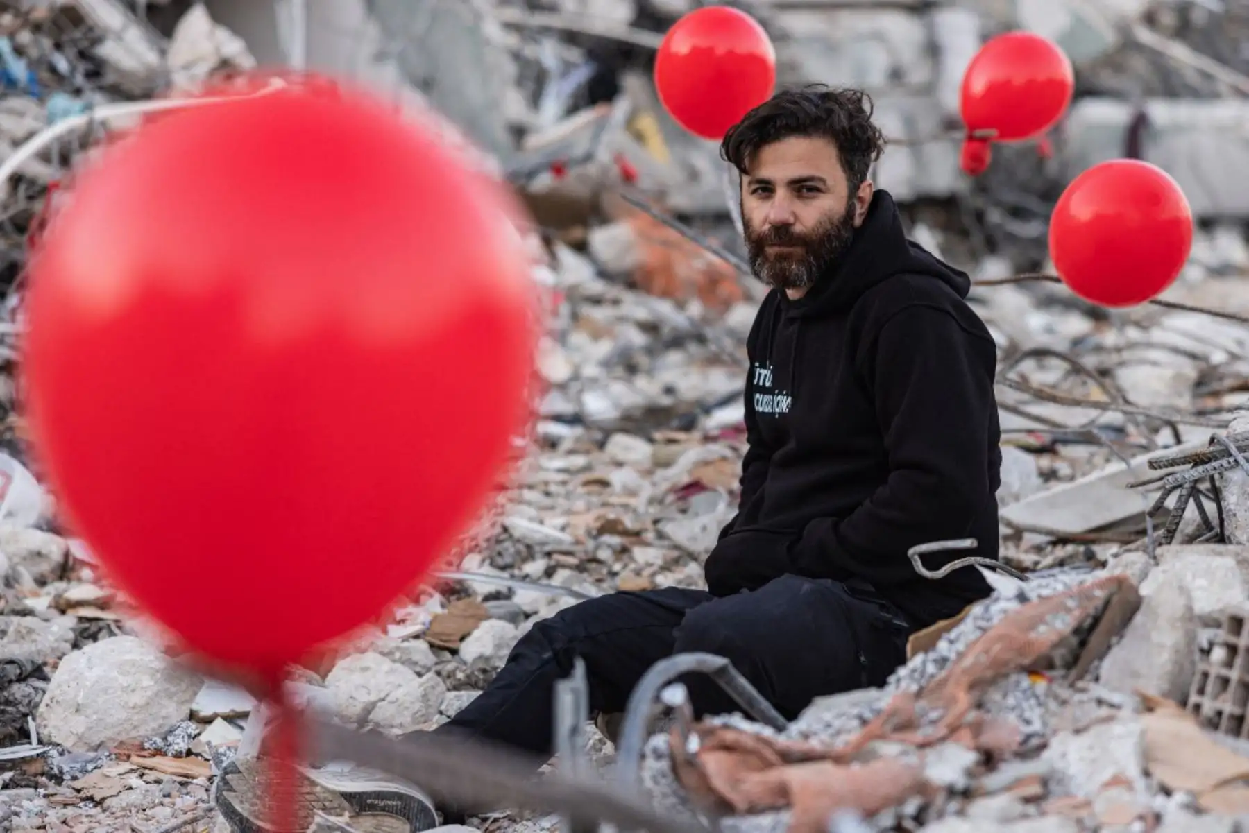 Globos rojos revolotean, colgando de las ruinas. Son "los últimos juguetes" de los niños fallecidos durante el terremoto que asoló esta ciudad del sur de Turquía, explica Ogun Sever Okur, autor de este regalo póstumo. Foto: AFP