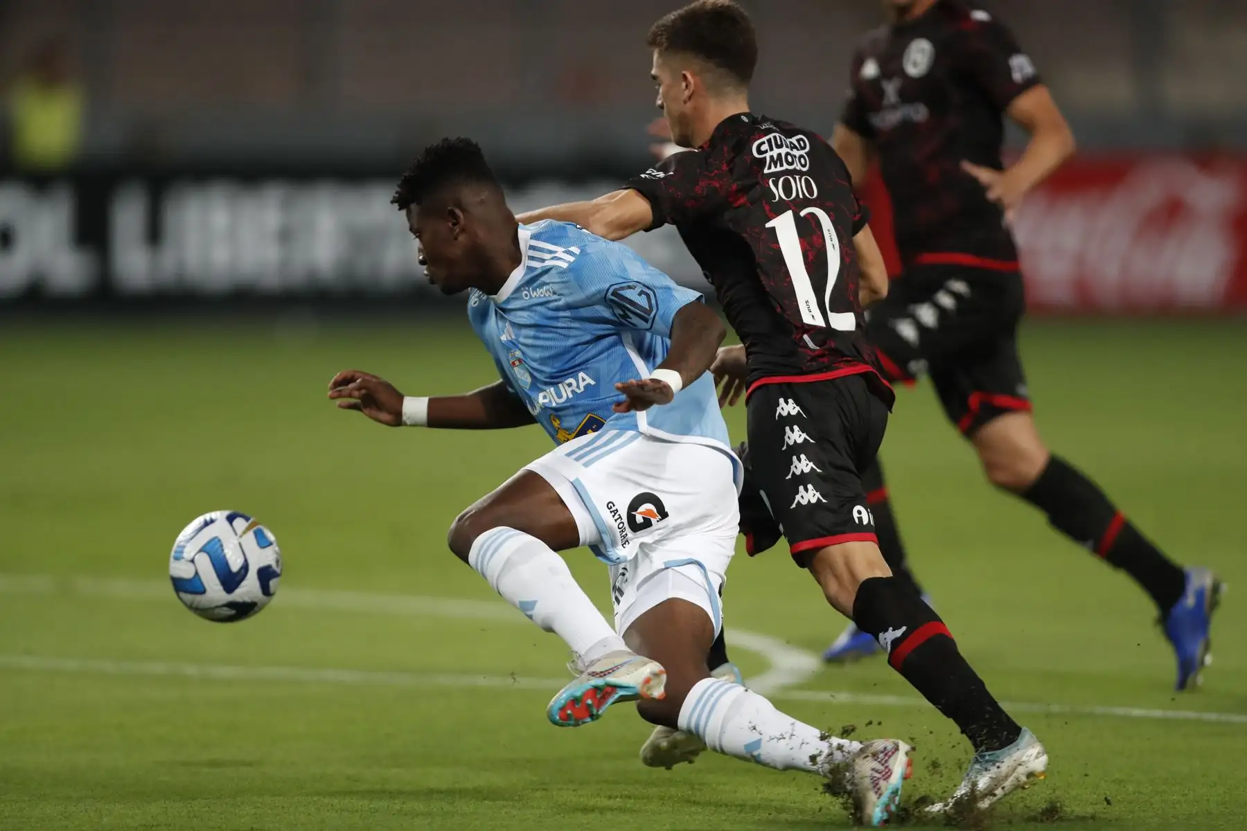 Washington Corozo (de Sporting disputa un balón con Guillermo Soto de Huracán hoy, durante un partido de la Copa Libertadores entre Sporting Cristal y Huracán en el estadio Nacional. Foto: EFE