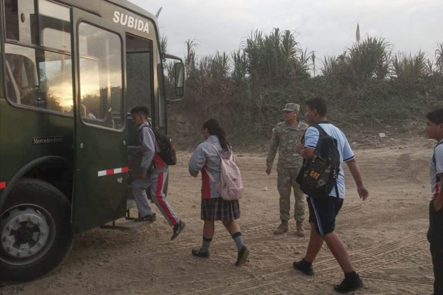 Tras el colapso del puente colgante sobre el río Zaña, los niños usaban un bote para ir al colegio. Ahora son trasladados en un bus del Ejército. Foto: ANDINA/Difusión