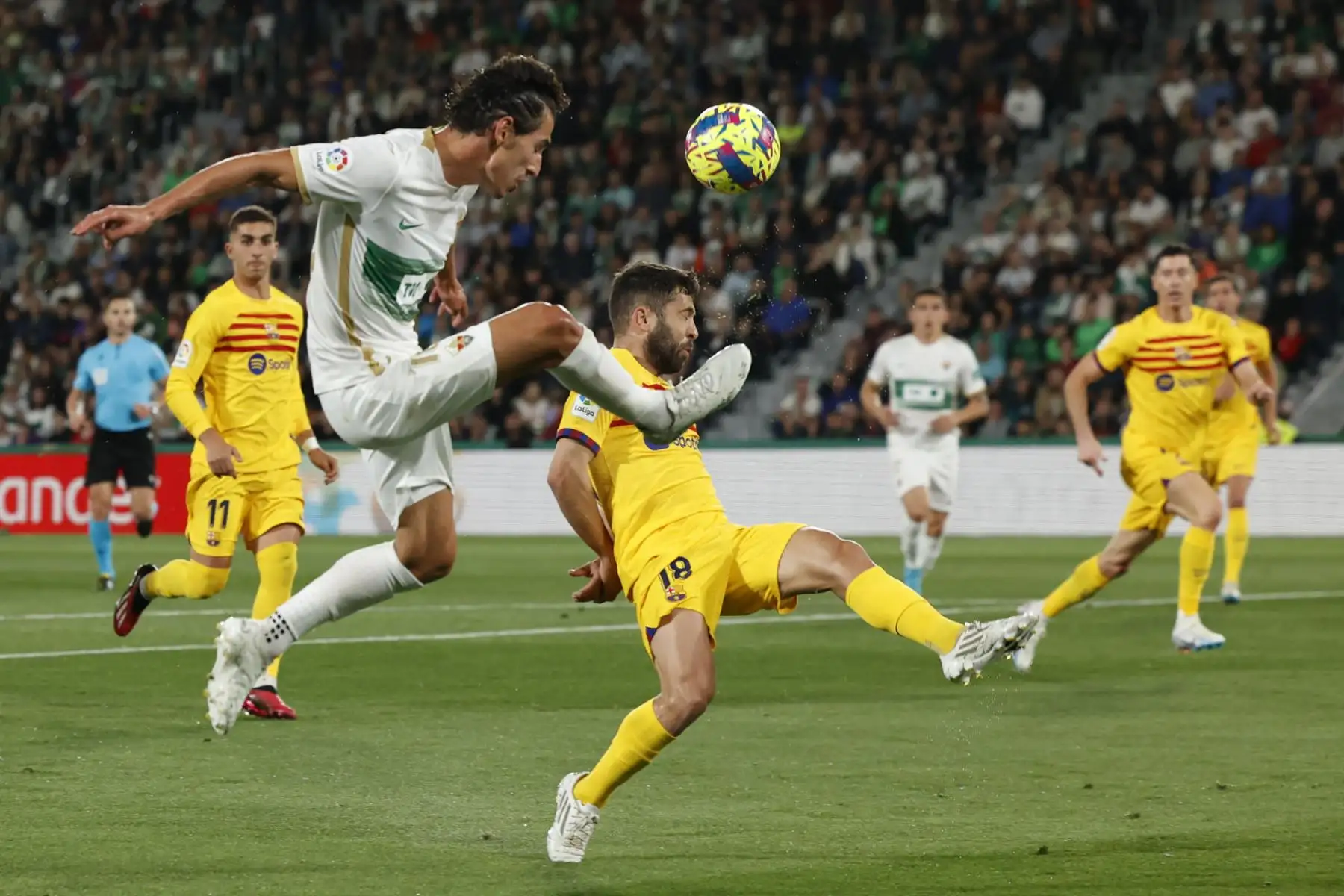 El delantero del Elche Pere Milla (i), ante el defensa del FC Barcelona Jordi Alba durante el encuentro correspondiente a la jornada 27 de primera división que disputan hoy sábado en el estadio Martinez Valero, en la localidad alicantina. Foto: EFE