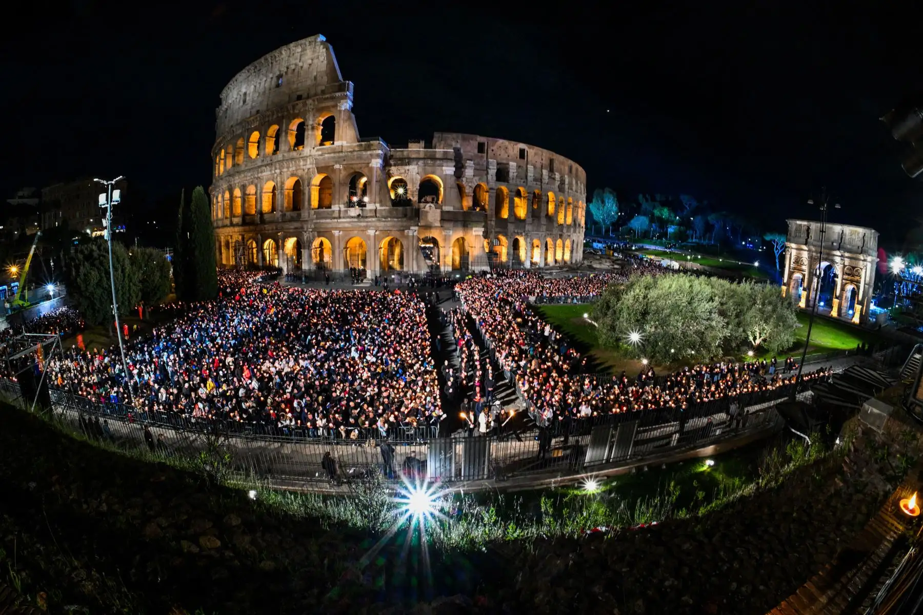 Una vista general muestra a las personas reunidas junto al monumento del Coliseo en Roma durante el servicio de oración del Camino de la Cruz (Via Crucis) en Roma.Foto: AFP