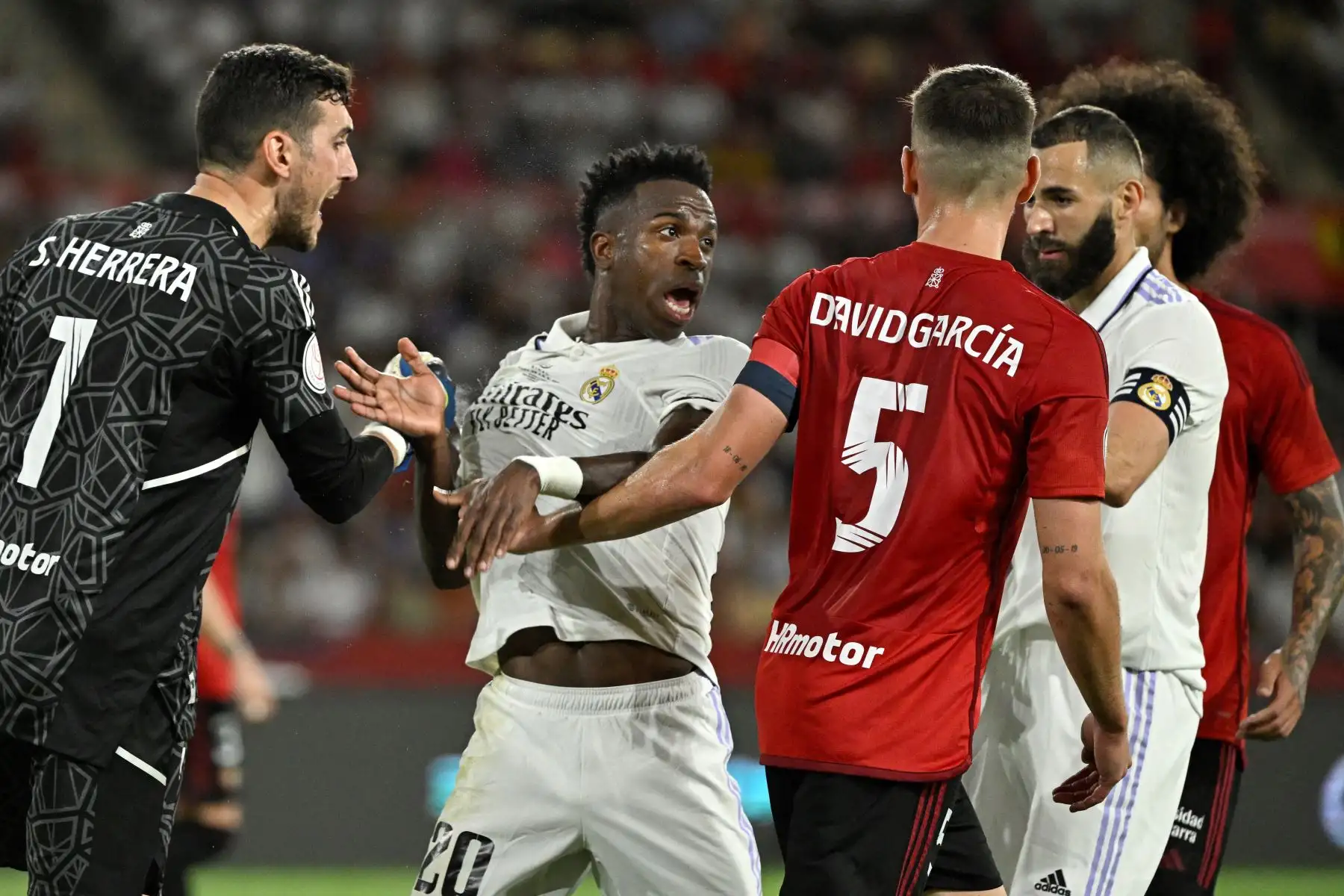 El delantero brasileño del Real Madrid, Vinicius Junior, habla con el defensor español de Osasuna, David García, durante el último partido de fútbol de la Copa del Rey de España entre el Real Madrid CF y el CA Osasuna en el estadio La Cartuja de Sevilla. Foto:ANDINA/ AFP