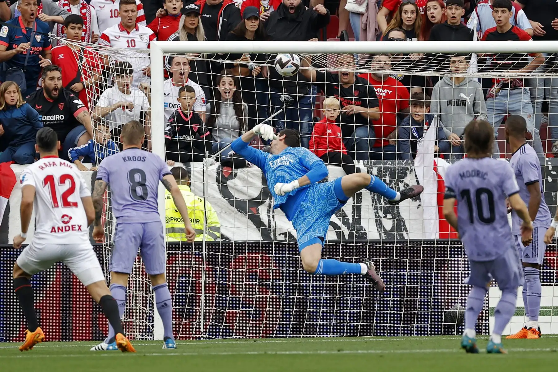 El delantero del Sevilla Rafa Mir  marca ante el portero belga del Real Madrid Thibaut Courtois durante el partido de la jornada 37 de LaLiga disputado este sábado en el estadio Sánchez Pizjuán. Foto:ANDINA/ EFE