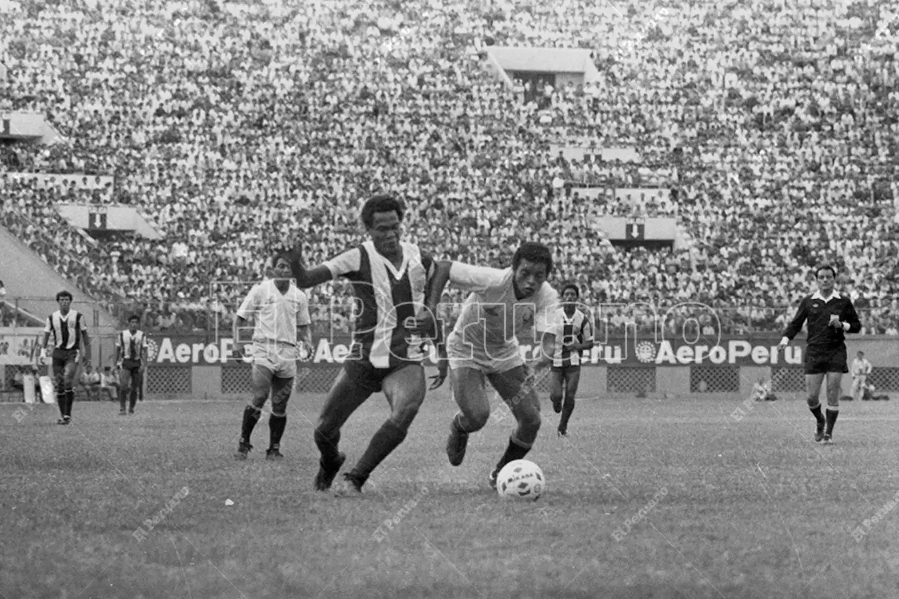 Lima - 22 diciembre 1985 / Eugenio La Rosa intenta superar la marca de Leo Rojas. Universitario de Deportes derrotó 1-0 a Alianza Lima en el clásico del fútbol peruano. Foto: Archivo Histórico de El Peruano / Américo Alburquerque