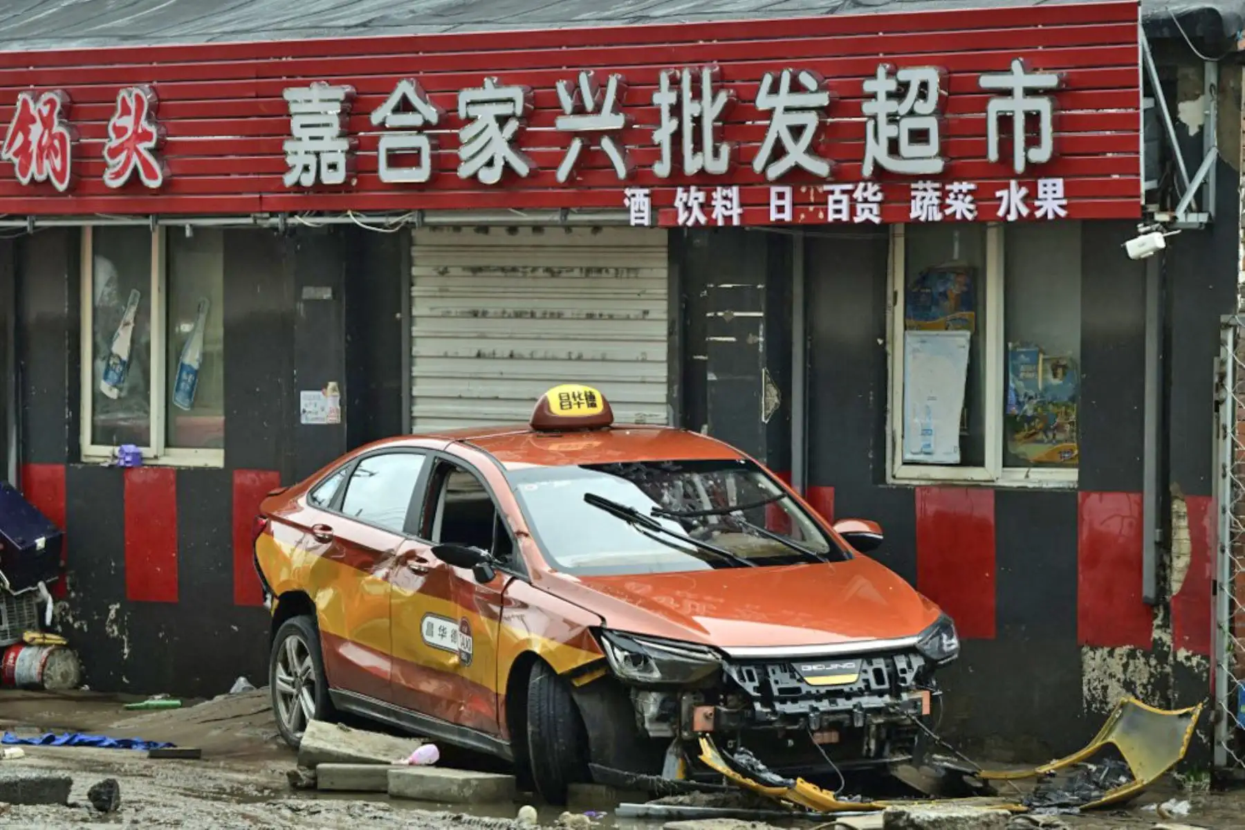 Se muestra un automóvil dañado después de las fuertes lluvias en el distrito de Fangshan en Beijing. Al menos 20 personas murieron y 19 desaparecieron después de que las fuertes lluvias azotaran Beijing. Foto: AFP
