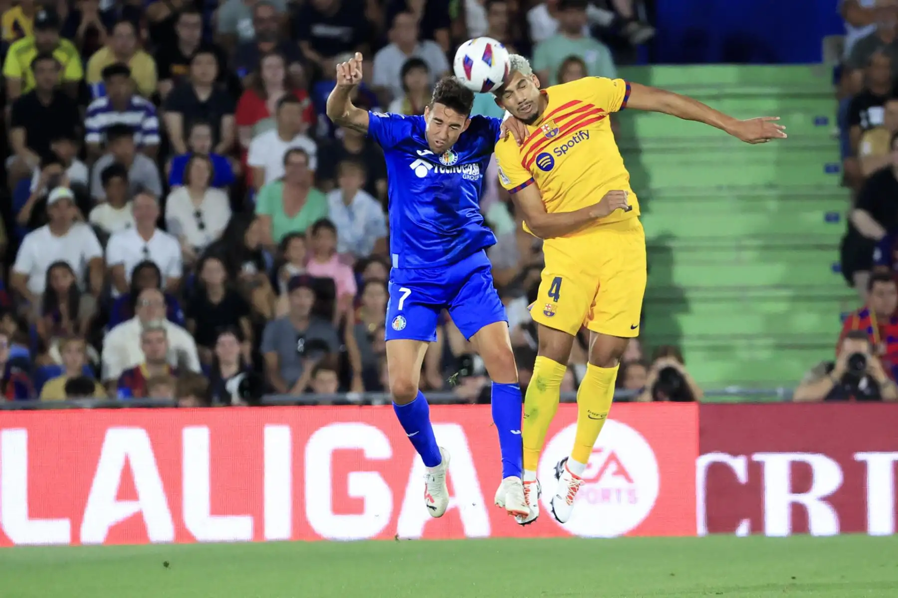 El defensa del FC Barcenola Ronald Araújo (d) salta para hacer un despeje junto a Jaime Mata, delantero del Getafe durante el partido de la primera jornada de LaLiga que disputan este domingo en el Coliseum Alfonso Pérez.
Foto: EFE