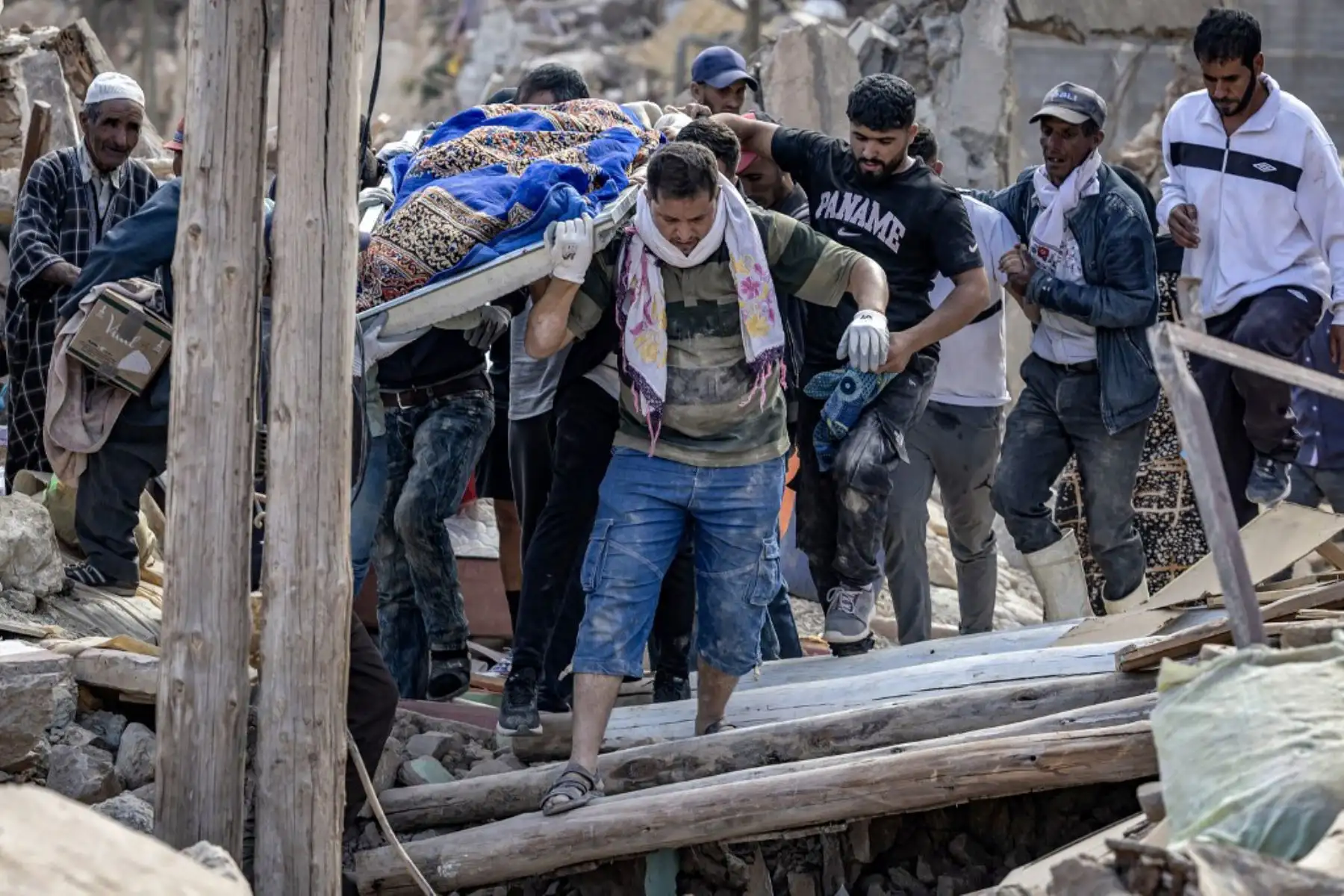 Voluntarios llevan los restos de una víctima del mortal terremoto de magnitud 6,8 ​​del 8 de septiembre, en la aldea de Imi N