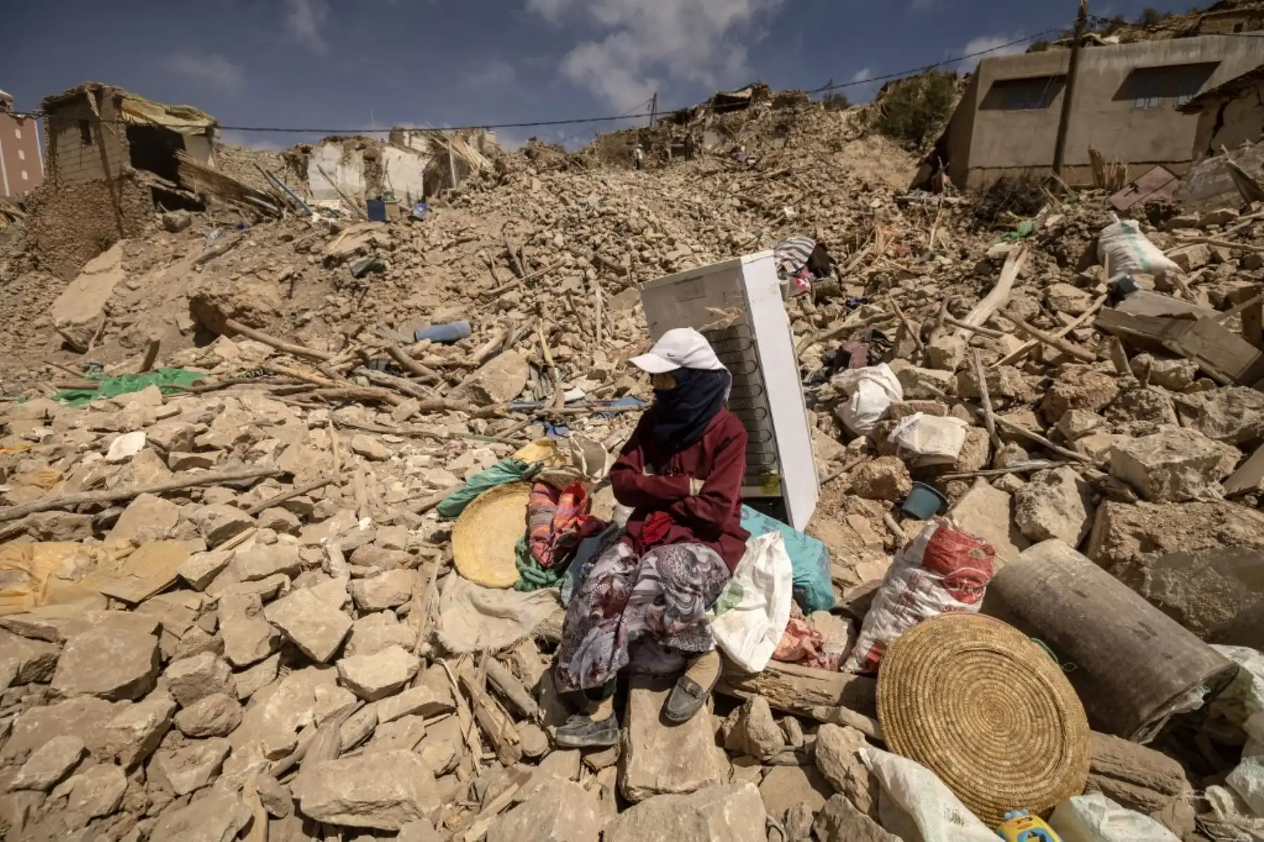 Una mujer en medio de los escombros en la aldea de Douzrou, afectada por el terremoto, en la provincia de al-Haouz, en las montañas del Alto Atlas en el centro de Marruecos. Foto: AFP