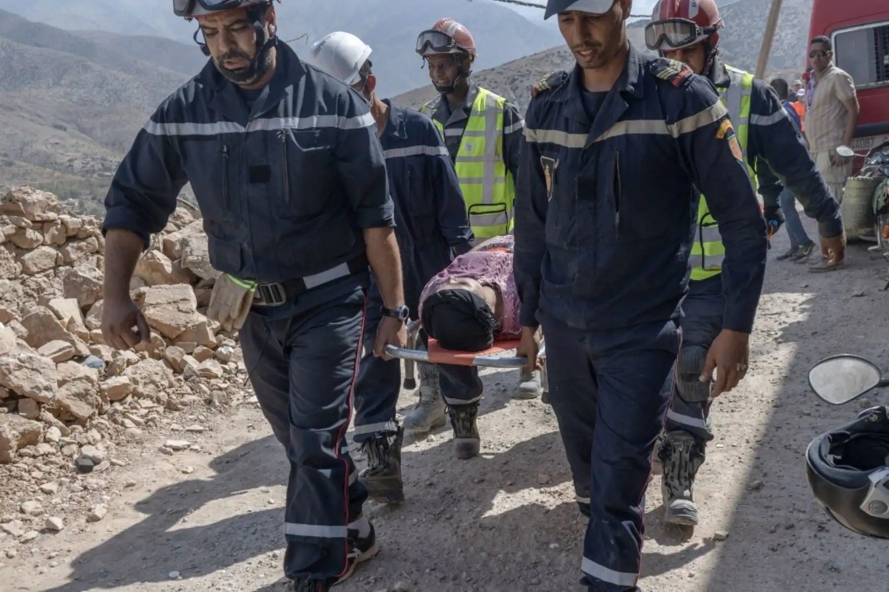 Rescatistas evacúan a una sobreviviente después de rescatarla de los escombros de una casa derrumbada por un terremoto en la aldea de Imi N