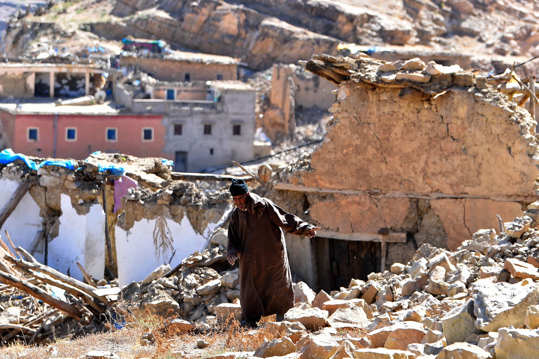 Un hombre camina entre los escombros de los edificios destruidos en la aldea de Ardouz, afectada por el terremoto, en la región marroquí de Amizmiz, el 14 de septiembre de 2023. Foto: AFP