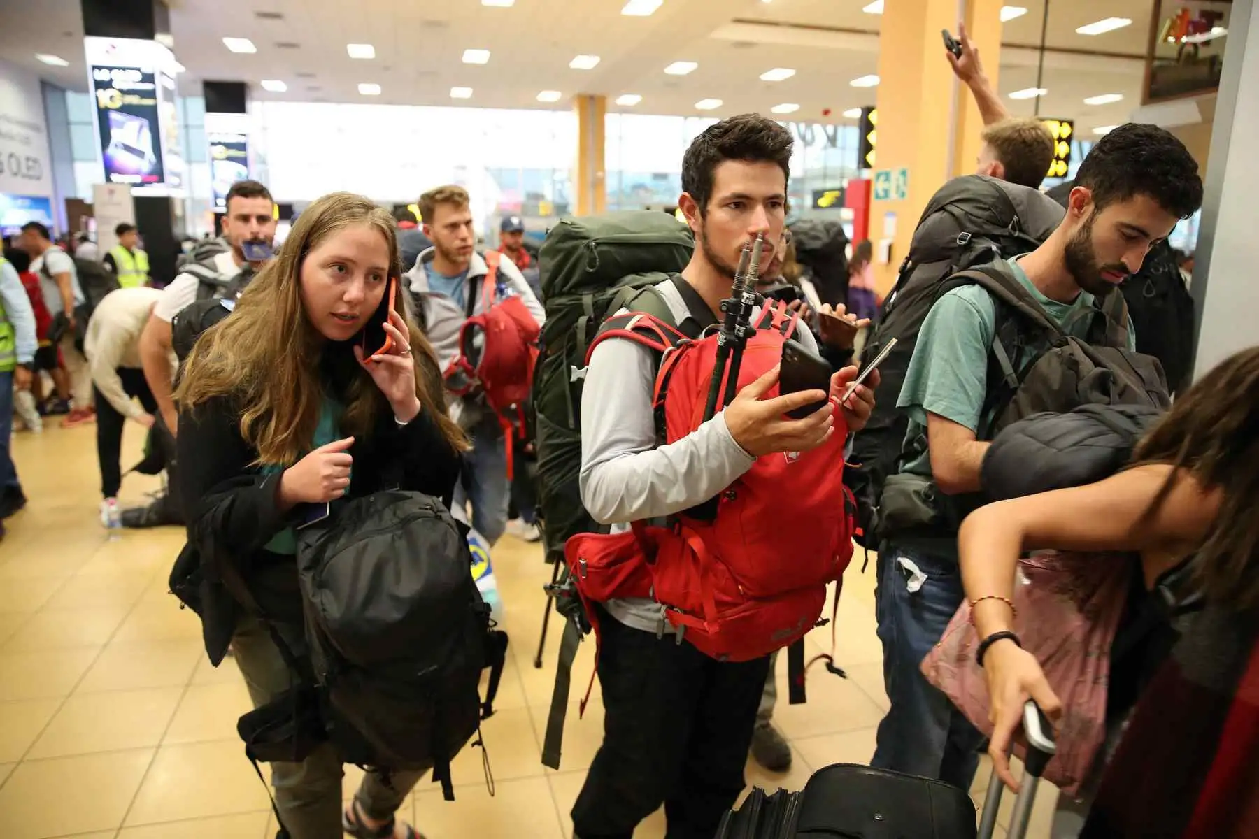 Jóvenes israelíes hacen cola para embarcarse en un vuelo con destino a Tel Aviv a las 21:20, hoy en el aeropuerto Internacional Jorge Chávez, en Lima (Perú). Foto: EFE