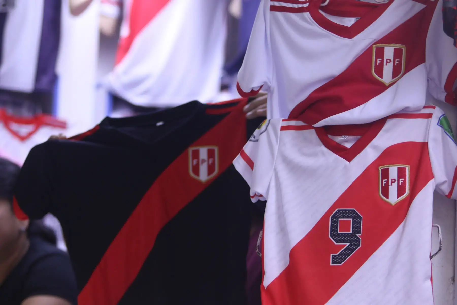 Este martes 21 se juega la sexta fecha de las Eliminatorias Sudamericanas rumbo al Mundial de Fútbol 2026 y la selección peruana se enfrenta al conjunto de Venezuela. Hinchas de la Blanquirroja y la Vinotinto acuden al emporio de Gamarra para comprar camisetas de sus respectivas escuadras para alentar a sus equipos.
Foto: ANDINA/Héctor Vinces