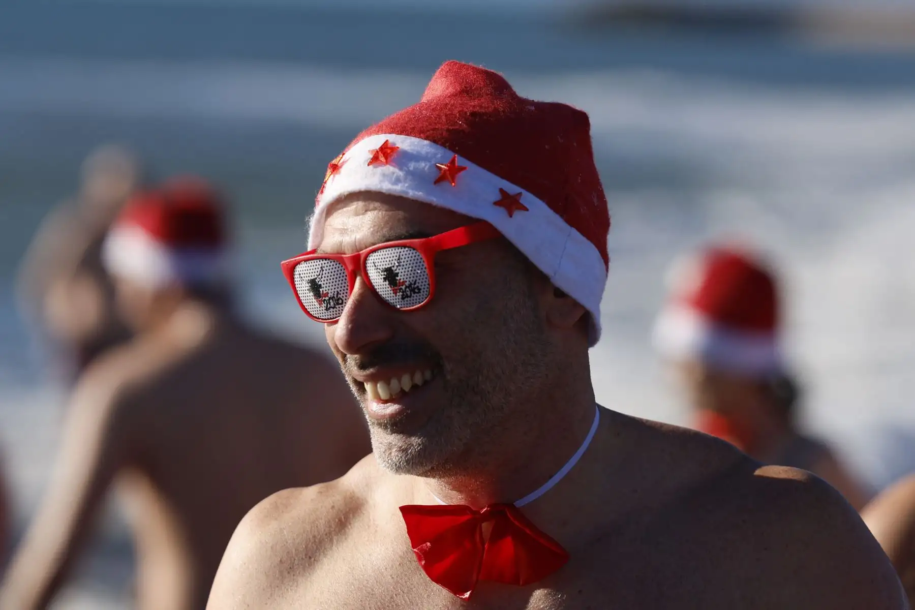 Cientos de personas disfrazadas de Papá Noel asisten al tradicional baño navideño de Valras, al sur de Francia, como antesala a las celebraciones de la Navidad. Foto: EFE