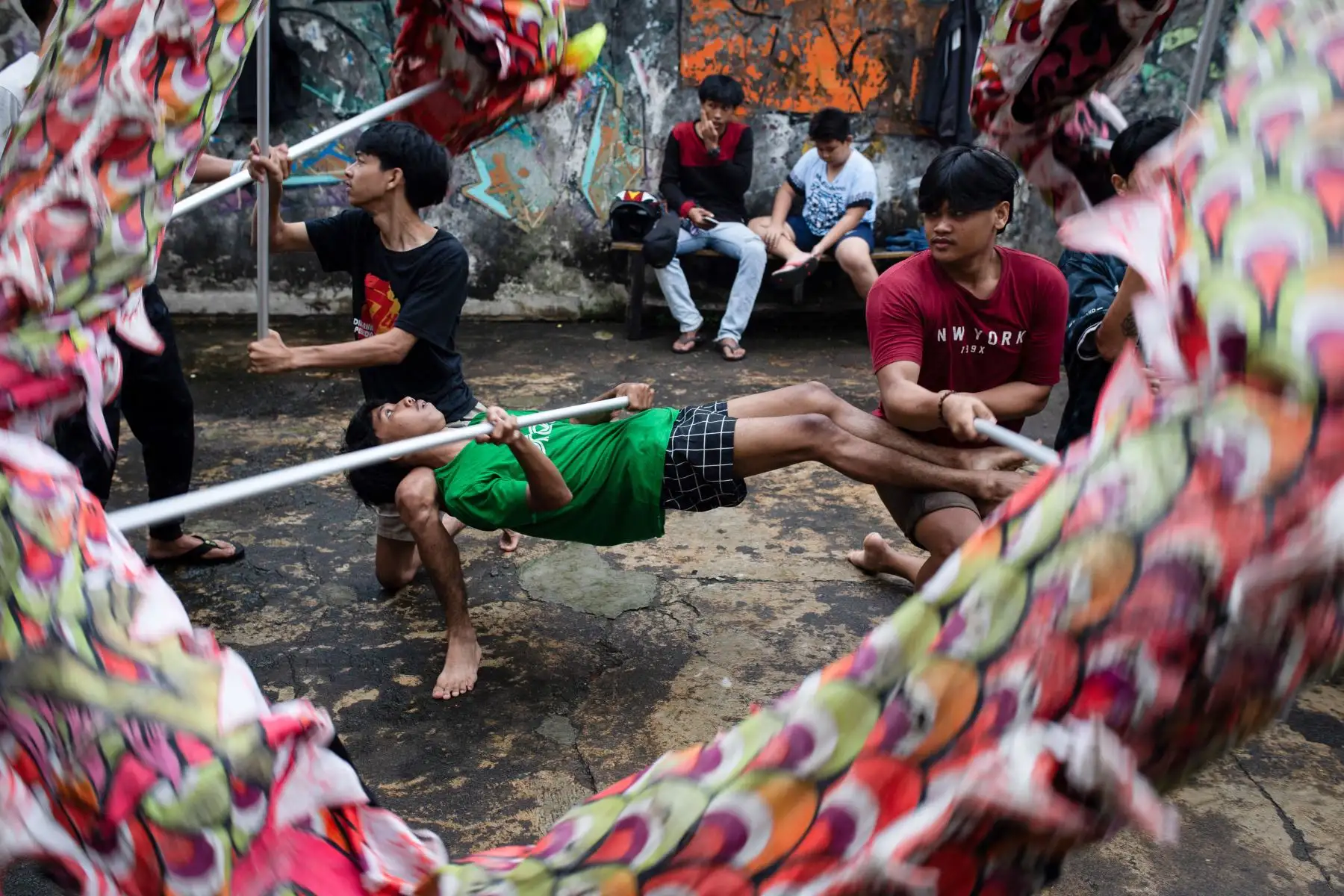 Los miembros de la comunidad practican realizar una danza tradicional del león antes del Año Nuevo Lunar Chino del Dragón en una fábrica abandonada en Bogor, Java Occidental. Foto: ANDINA/AFP)