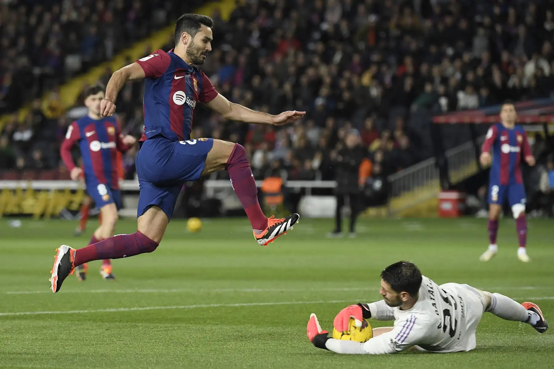 El portero argentino del Granada , Augusto Batalla salva el balón mientras el mediocampista alemán del Barcelona,  Ilkay Gundogan salta sobre él durante el partido de fútbol de la liga española entre el FC Barcelona y el Granada FC en el Estadi Olimpic Lluis Companys de Barcelona.
Foto: AFP