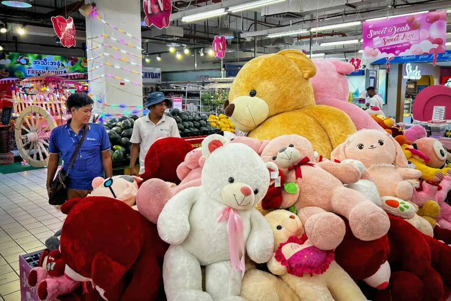 Los clientes pasan junto a una pila de juguetes de peluche en un centro comercial el día de San Valentín en Yangon. Foto: AFP