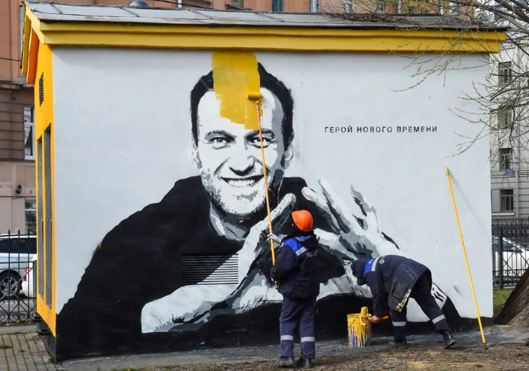 Un trabajador pinta sobre un graffiti del crítico del Kremlin encarcelado Alexei Navalny en San Petersburgo el 28 de abril de 2021. Foto: AFP