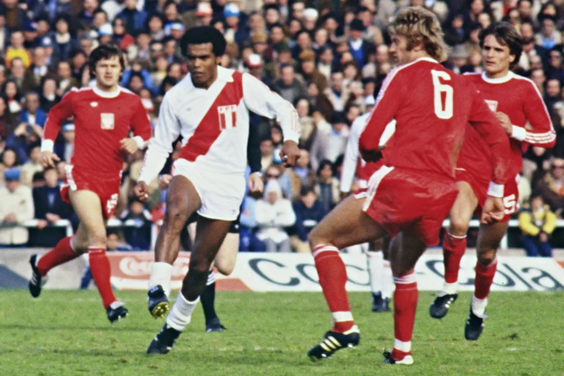 El delantero peruano Teófilo Cubillas corre entre defensores polacos durante el partido de segunda ronda del Mundial de fútbol entre Polonia y Perú. Foto: AFP