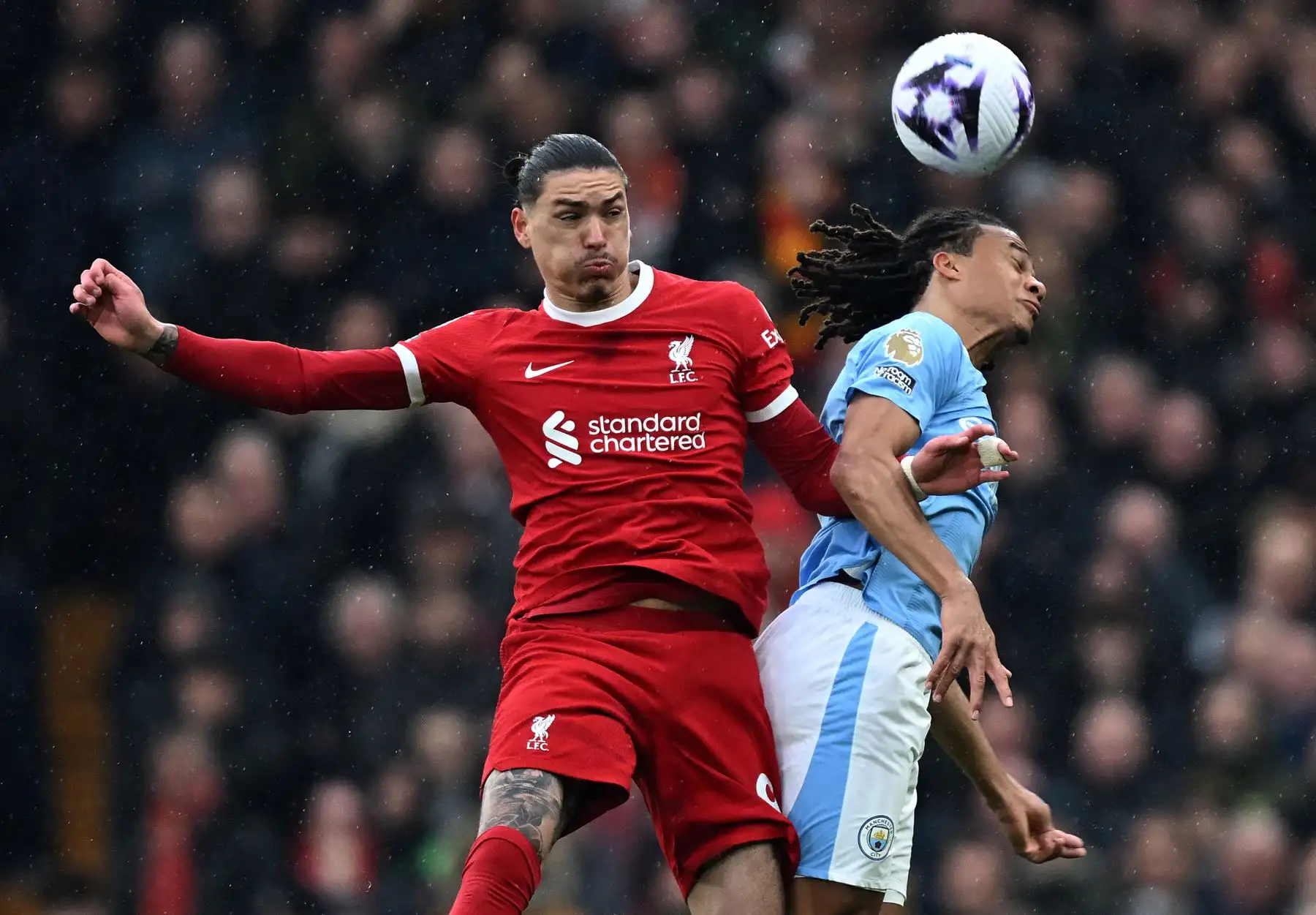 El delantero uruguayo del Liverpool  Darwin Núñez y el defensor holandés del Manchester City  Nathan Ake compiten por cabecear el balón durante el partido de fútbol de la Premier League inglesa entre Liverpool y Manchester City.
Foto: ANDINA/AFP