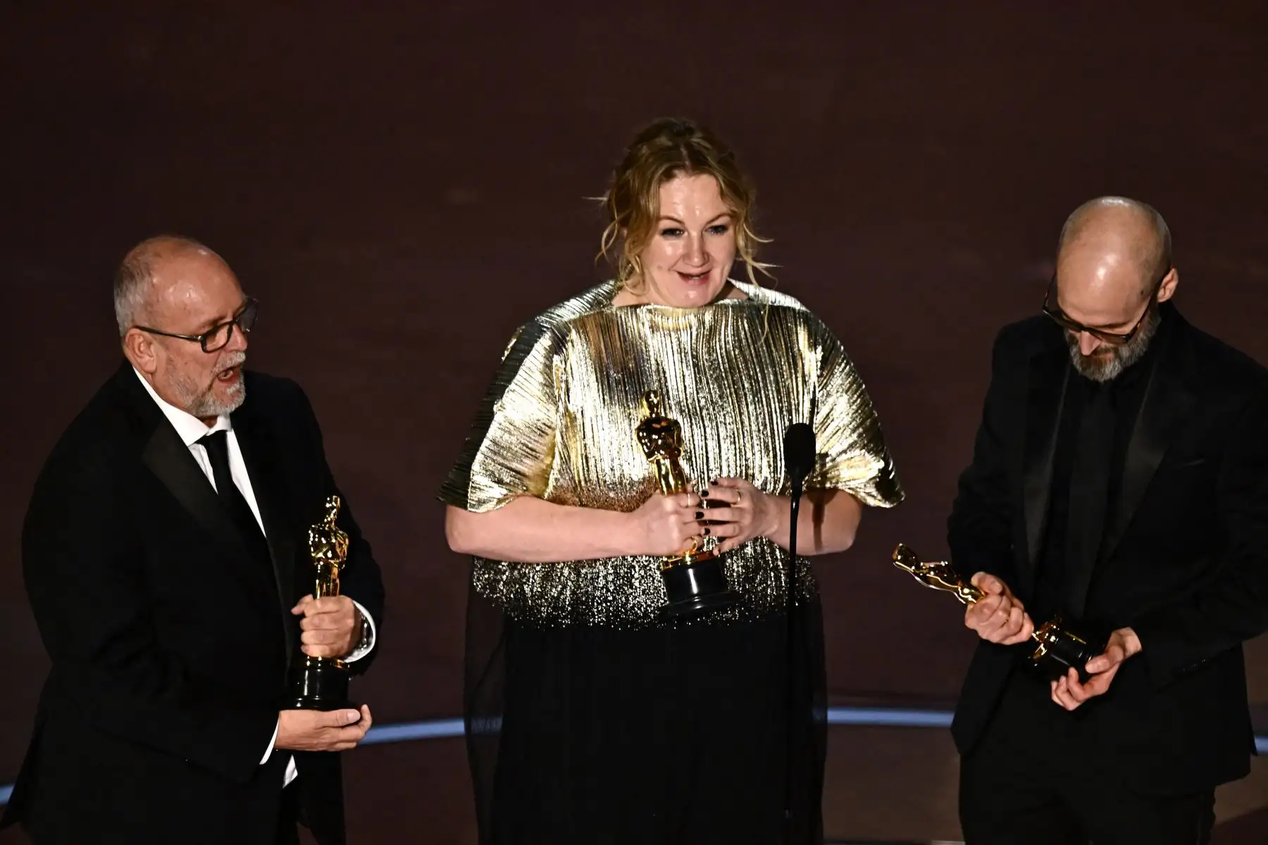 British makeup artists Josh Weston (R), Nadia Stacey (C) and Mark Coulier accept the award for Best Makeup and Hairstyling onstage for "Poor Things" during the 96th Annual Academy Awards at the Dolby Theatre in Hollywood, California