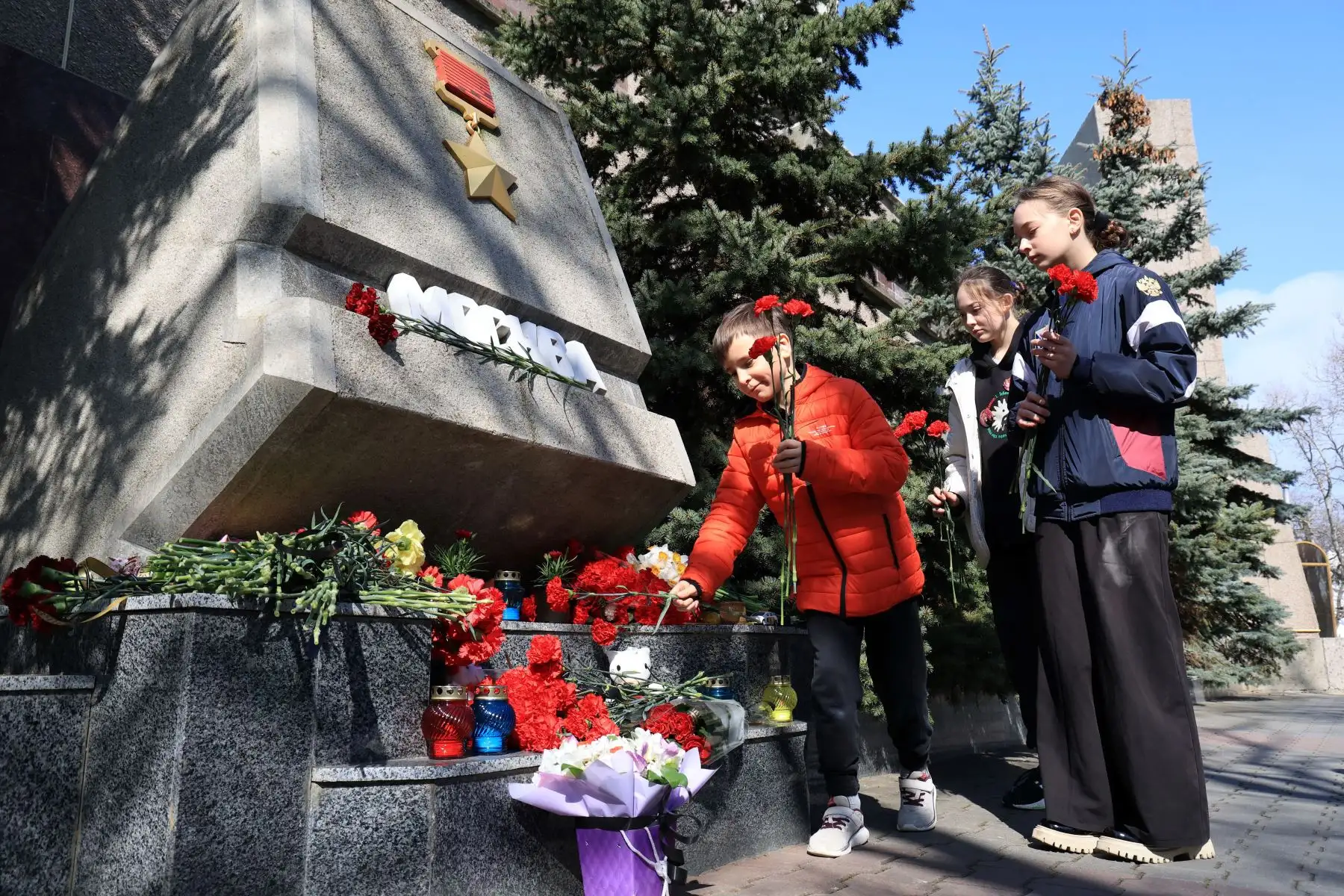 La gente deposita flores en una piedra conmemorativa que dice "Moscú", en el Callejón de las Ciudades Héroes en Sebastopol, Crimea, en memoria de las víctimas de un ataque con armas de fuego en el Ayuntamiento de Crocus en la ciudad rusa de Krasnogorsk. Hombres armados camuflados abrieron fuego en el abarrotado Ayuntamiento de Crocus en el suburbio de Krasnogorsk, al norte de Moscú. Foto: ANDINA/AFP