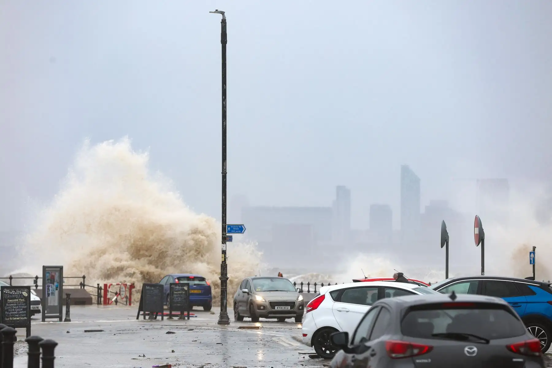 Los automovilistas conducen a través de escombros y aguas inundadas mientras las olas rompen contra el malecón en New Brighton, Gran Bretaña, el 9 de abril de 2024. La Oficina Meteorológica del Reino Unido ha emitido advertencias meteorológicas amarillas por viento y lluvia, ya que la tormenta Pierrick trae fuertes vientos y fuertes lluvias a las zonas costeras. Foto: EFE