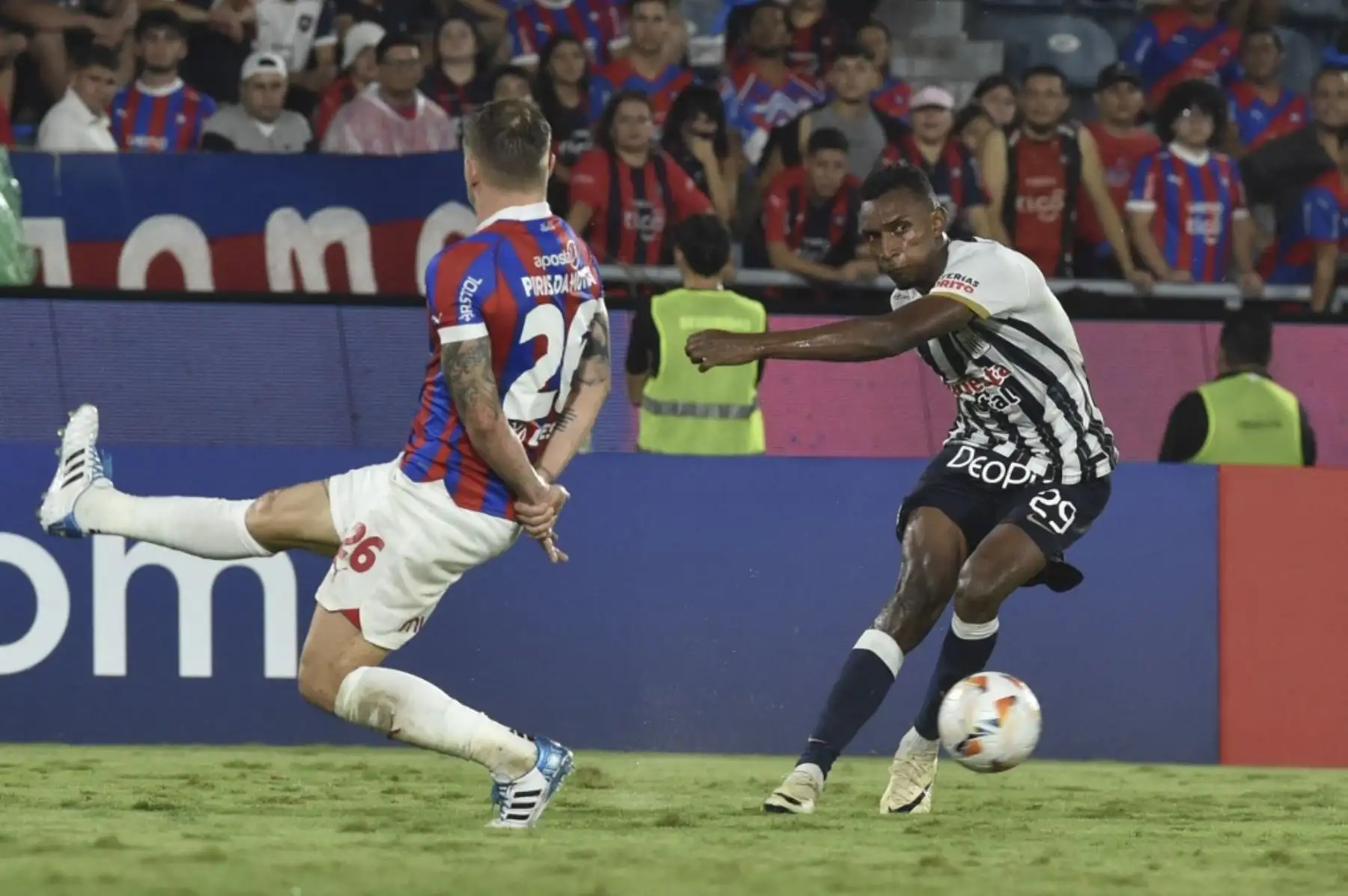 El mediocampista de Cerro Porteño, Robert Piris da Motta (i), y el defensor panameño de Alianza Lima, Jiovany Ramos, luchan por el balón durante el partido de fútbol de ida de la fase de grupos de la Copa Libertadores entre Cerro Porteño de Paraguay y Alianza Lima de Perú en el estadio La Nueva Olla. Foto: AFP