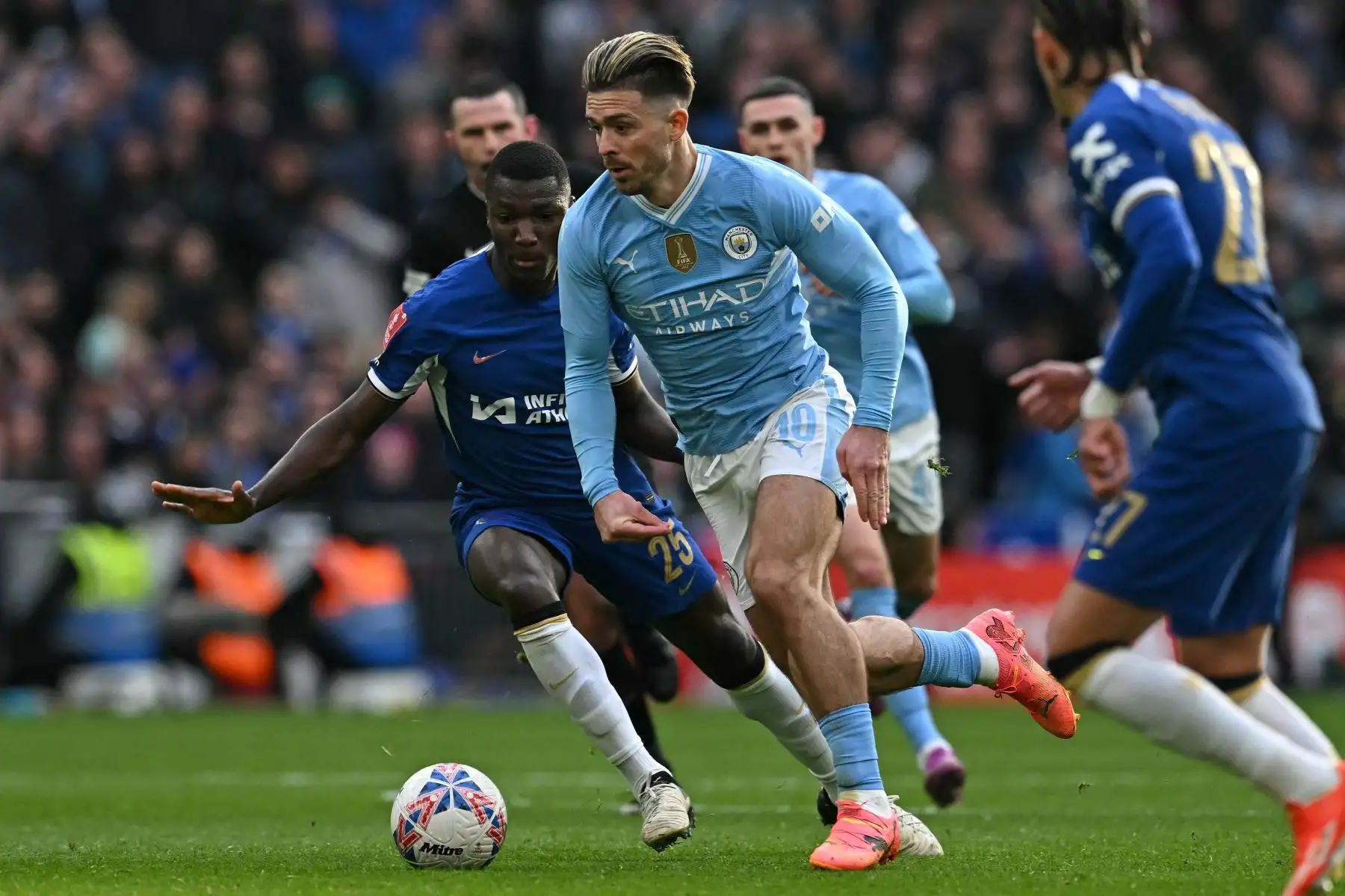 El centrocampista inglés del Manchester City Jack Grealish  corre con el balón durante el partido de fútbol semifinal de la Copa FA inglesa entre Manchester City y Chelsea. Foto: ANDINA/ AFP