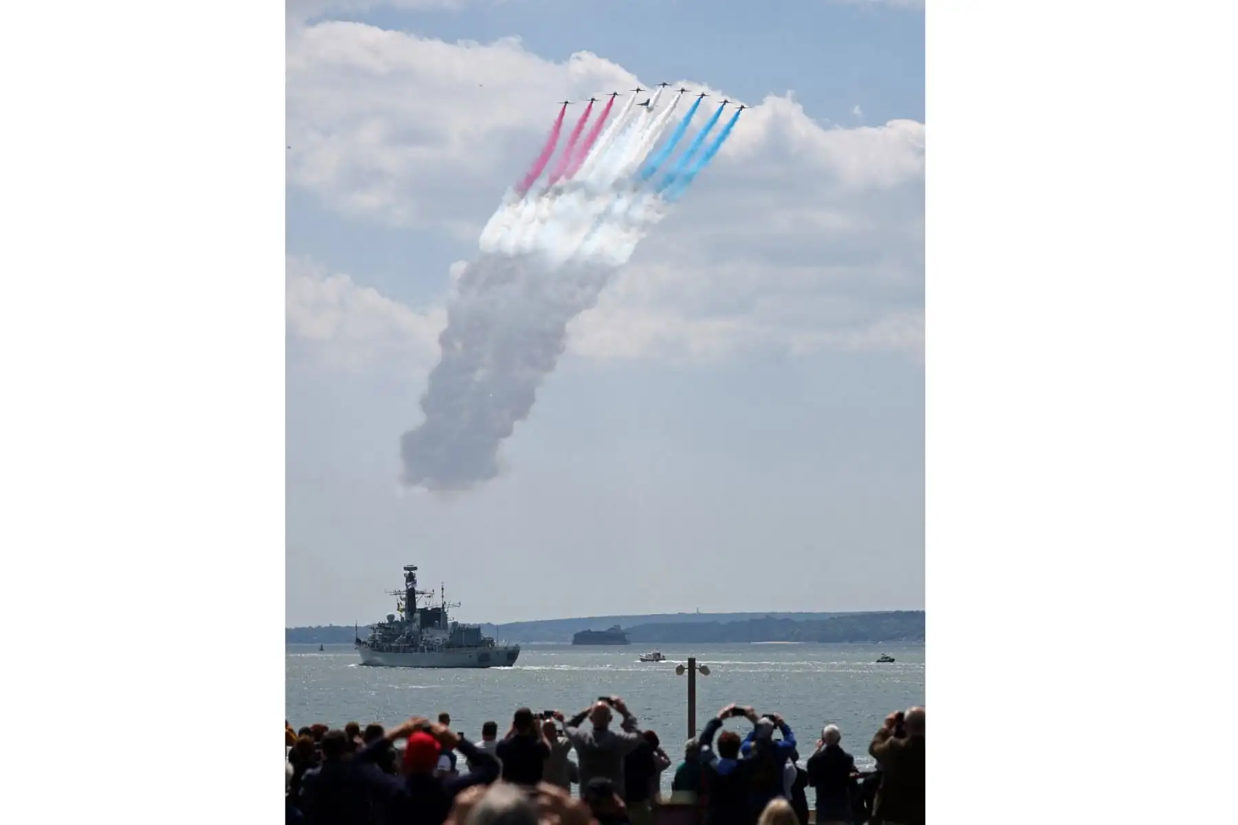 Los miembros del público observan cómo el equipo acrobático de la Real Fuerza Aérea Británica (RAF), las "Flechas Rojas", realizan un vuelo sobre el HMS St Albans, una fragata Tipo 23, durante un evento conmemorativo nacional del Reino Unido para conmemorar el 80º aniversario de las actividades anfibias aliadas. Foto: AFP