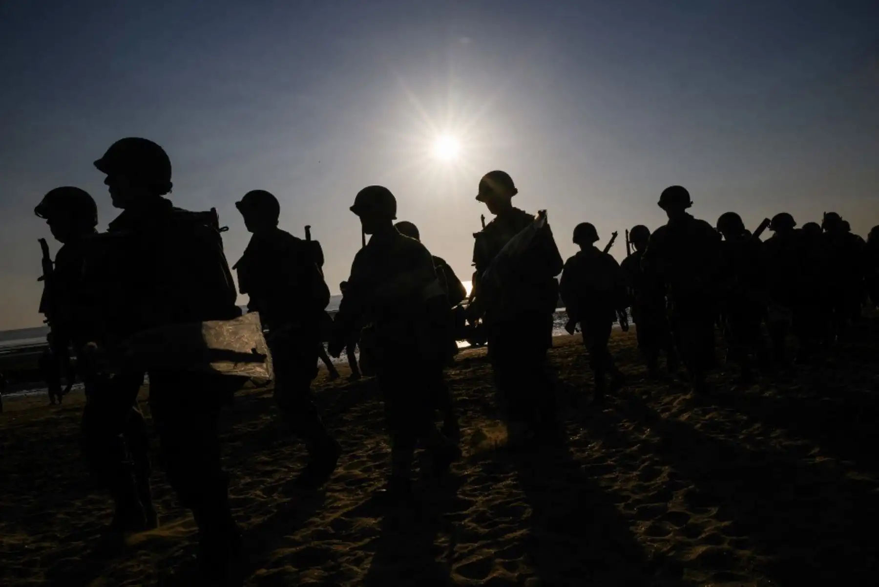 Entusiastas vestidos con réplicas de atuendos militares de la Segunda Guerra Mundial del ejército estadounidense se reúnen en Utah Beach el 6 de junio de 2024, durante las conmemoraciones del "Día D" que marcan el 80 aniversario del desembarco aliado de la Segunda Guerra Mundial en Normandía. Foto: AFP