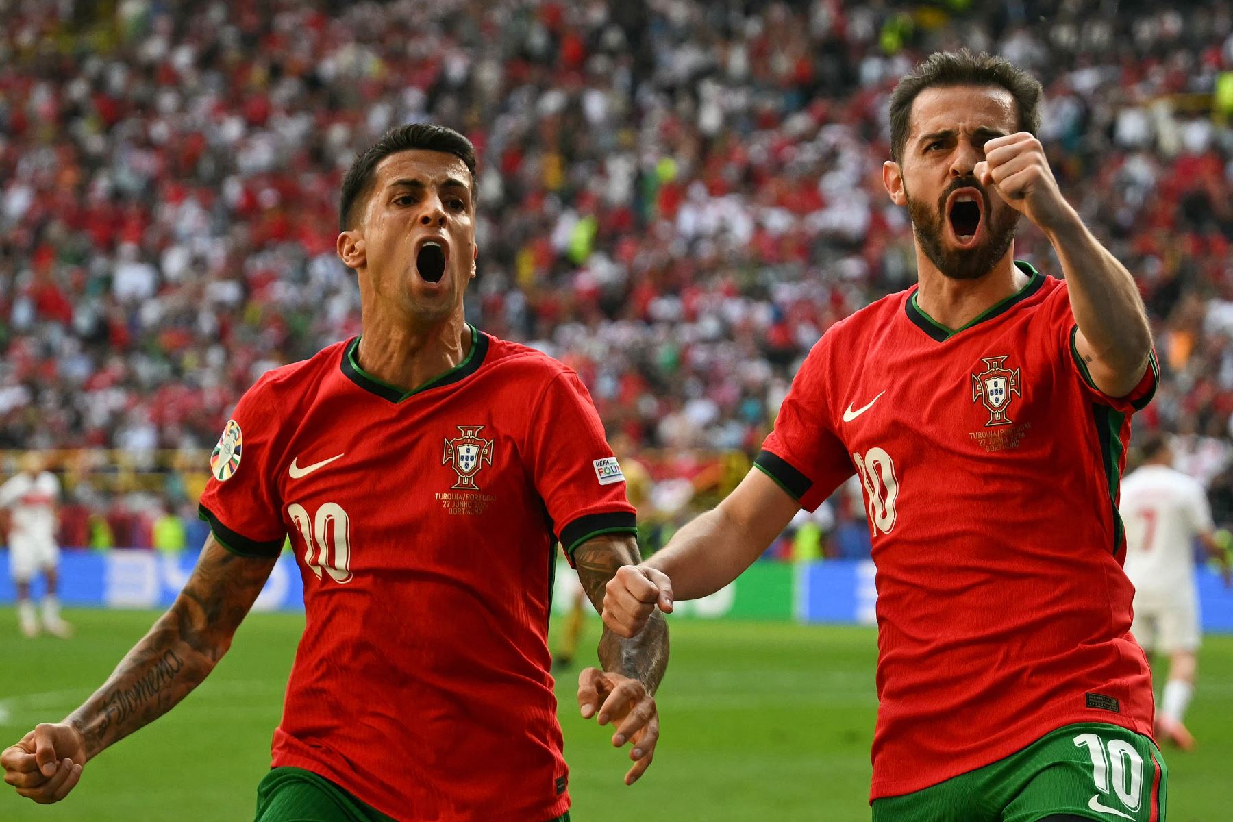 El centrocampista portugués  Bernardo Silva celebra marcar el primer gol de su equipo con el defensor portugués  Joao Cancelo  durante el partido de fútbol del Grupo F de la UEFA Euro 2024 entre Turquía y Portugal. AFP