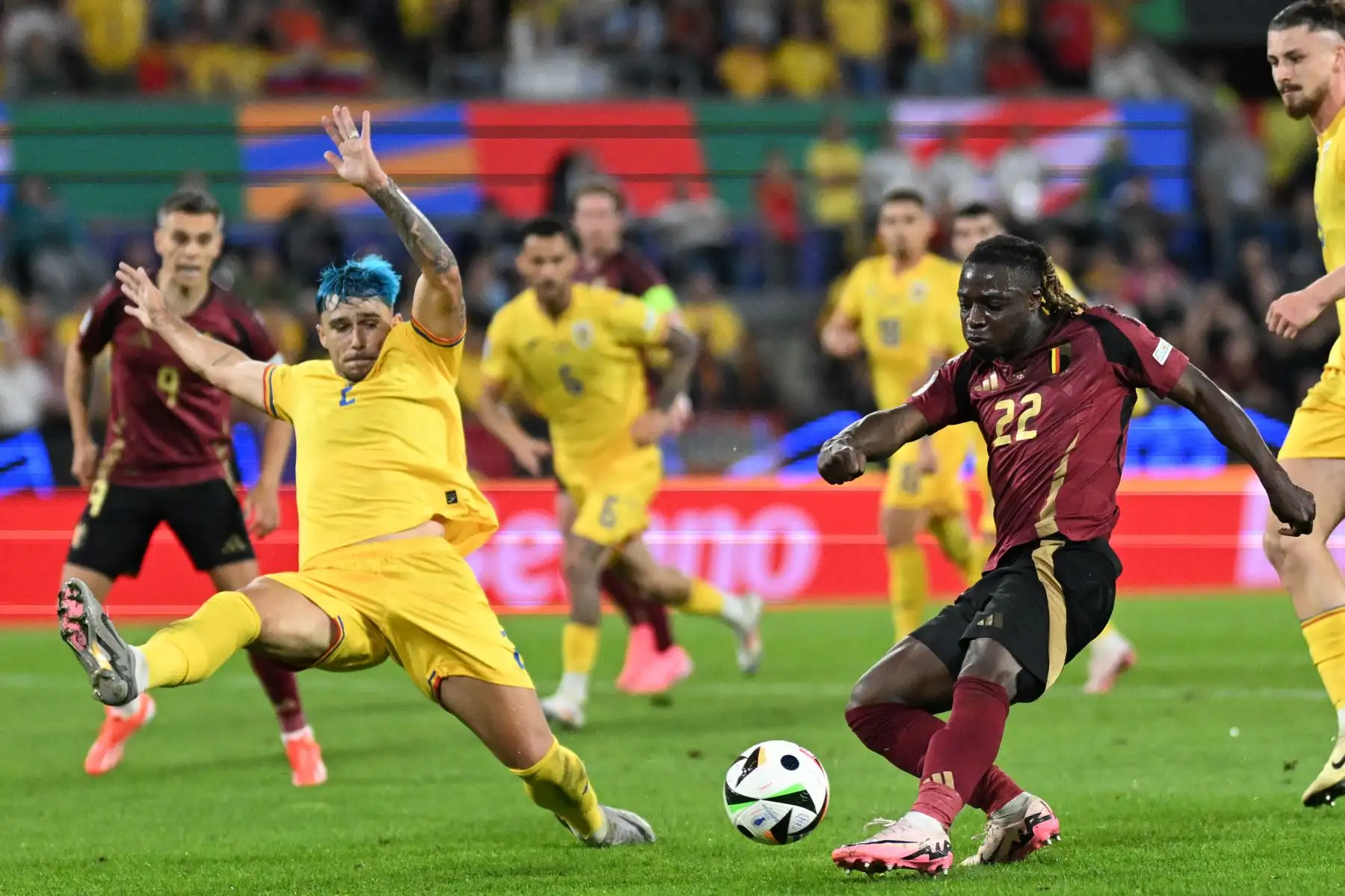 El delantero belga Jeremy Doku dispara al defensor rumano Andrei Ratiu durante el partido de fútbol del Grupo E de la UEFA Euro 2024 entre Bélgica y Rumania en el estadio de Colonia.
Foto: AFP